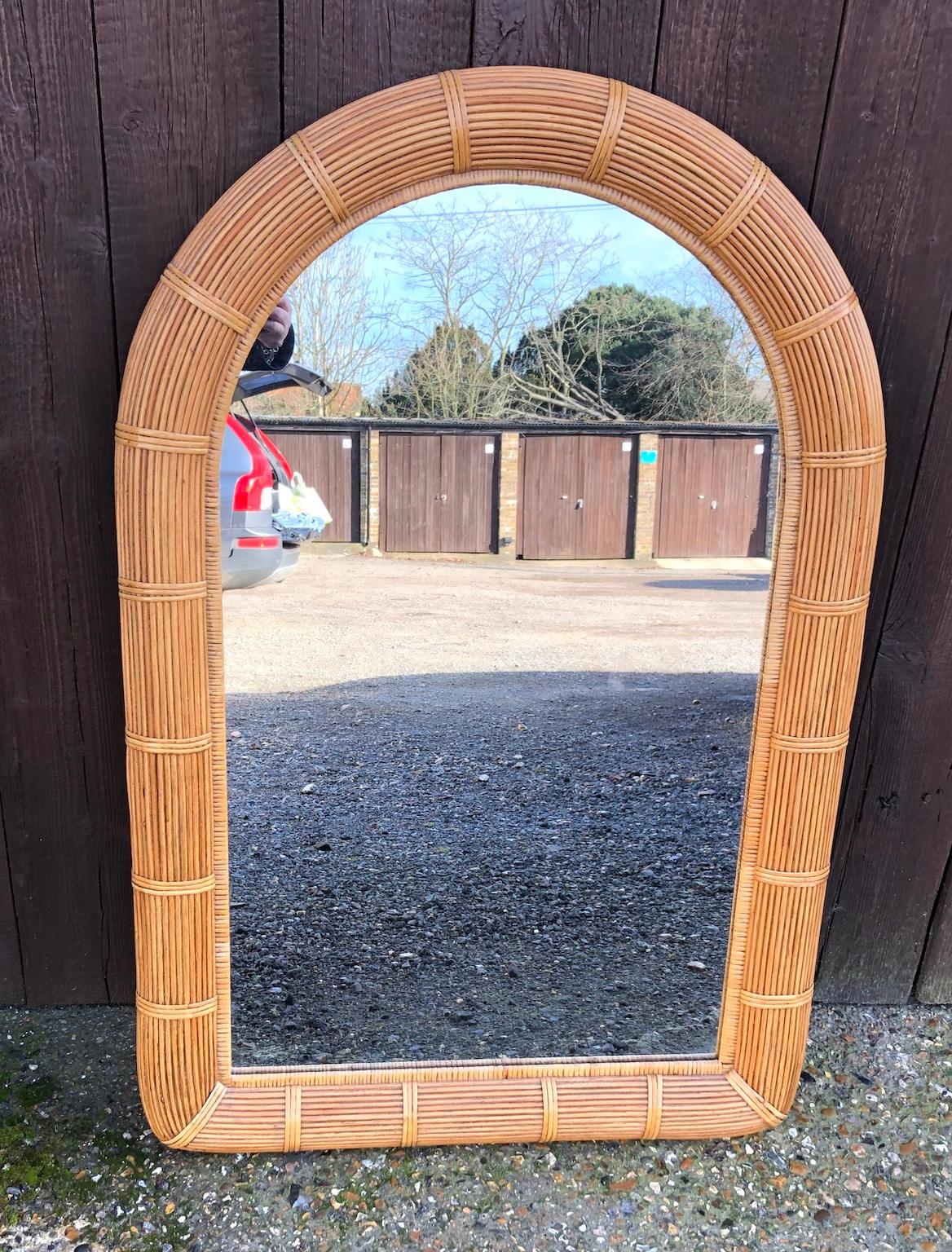 Midcentury stick rattan arch top wall mirror with rattan wrappings, American. 1970s

This truly stunning midcentury mirror with arch top decoration, on rectangular shape is made up of stick rattan, 
accented by large rattan wrappings. Wooden