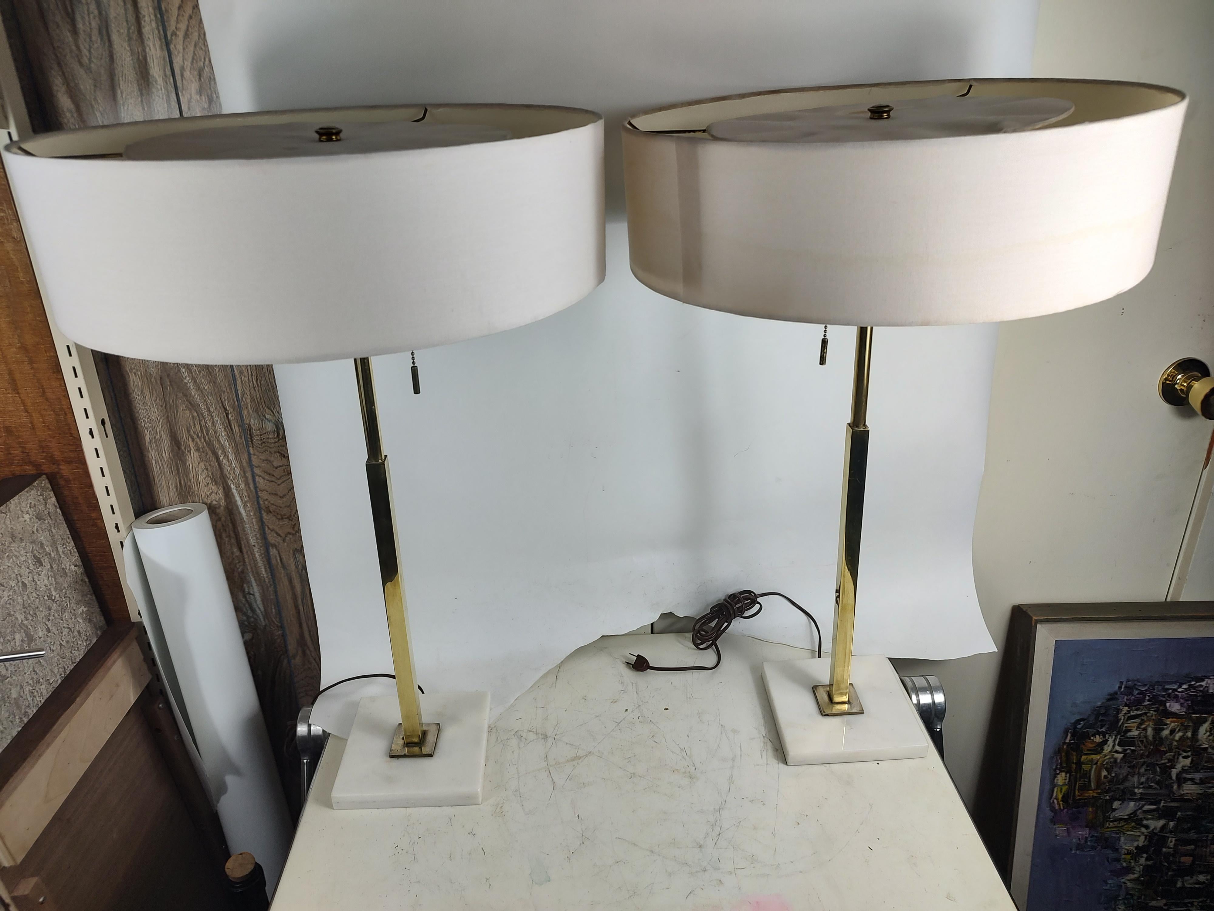 Simple and elegant pair of Mid-Century Modern table lamps with square to round stems on marble plinths. Signed Stiffel on the sockets. Shades to be recovered. In excellent vintage condition with minimal wear. Sold and priced as a pair.