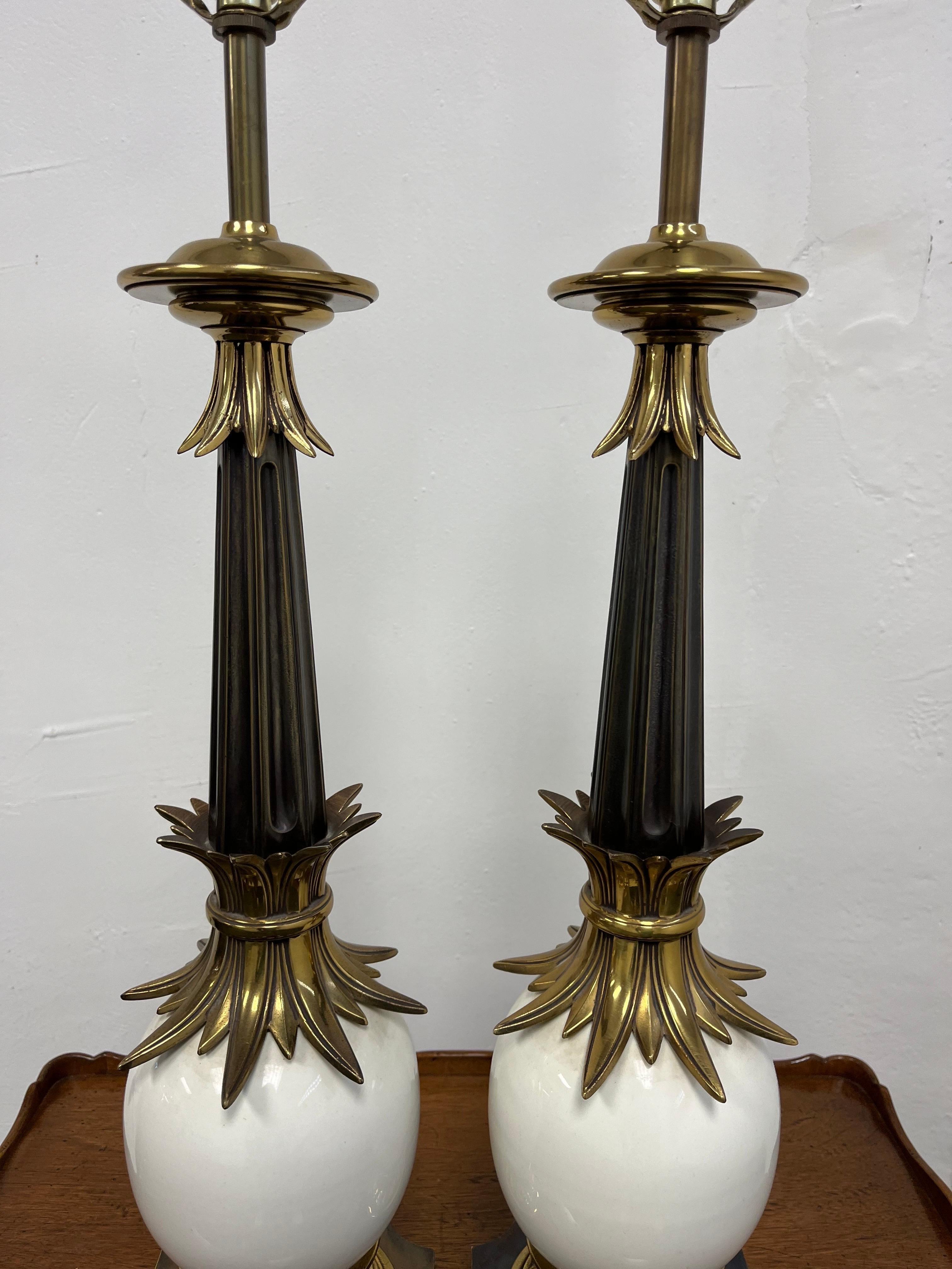 Striking pair of Ostrich egg lamps by Stiffel. Well constructed lamps are made with brass and porcelain and solid brass finial. Condition is excellent.