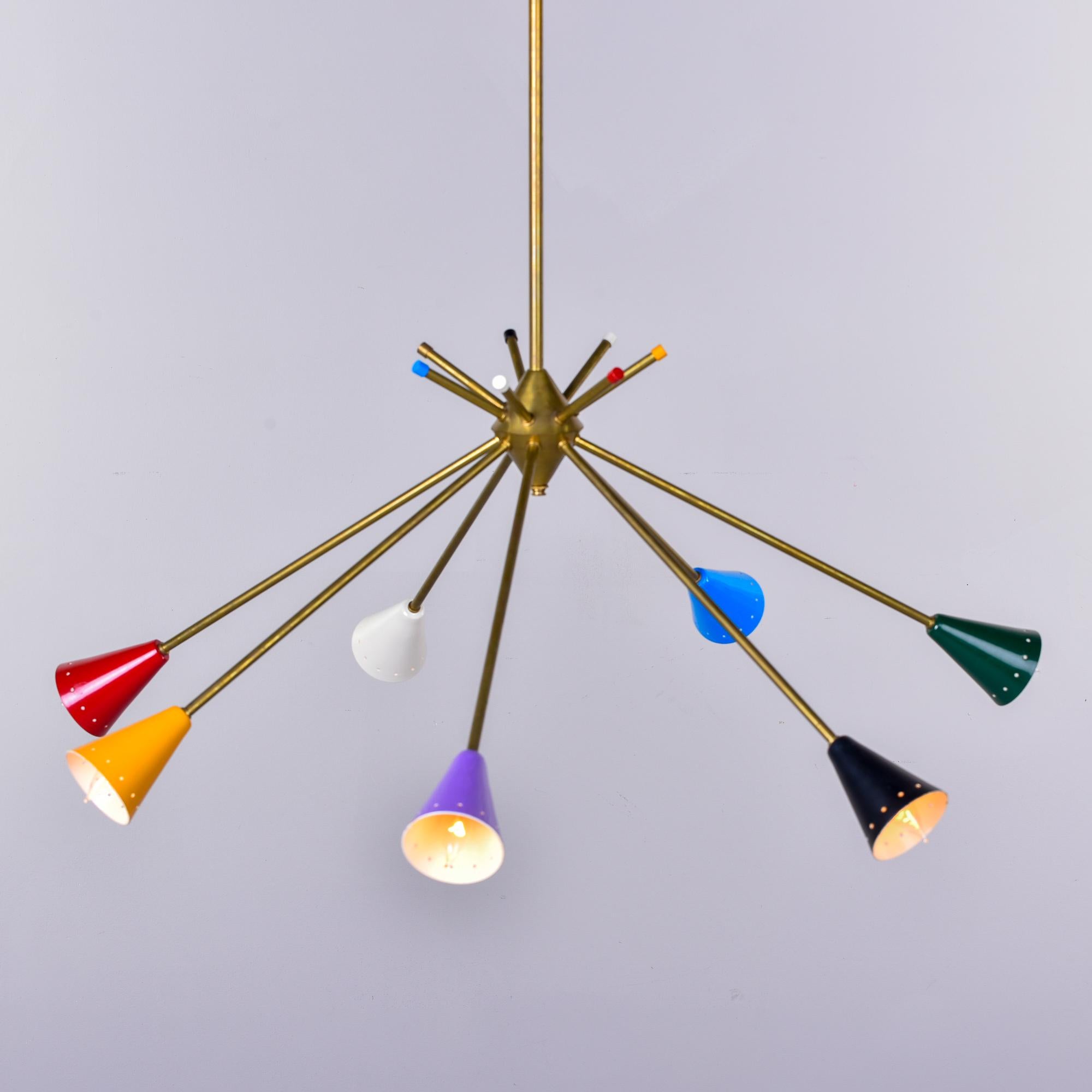 Found in Italy, this circa 1960 light fixture is attributed to Stilnovo. This fixture has a slender brass frame and support rod with seven arms ending in multi-colored metal shades. Wiring has been updated for US electrical standards.