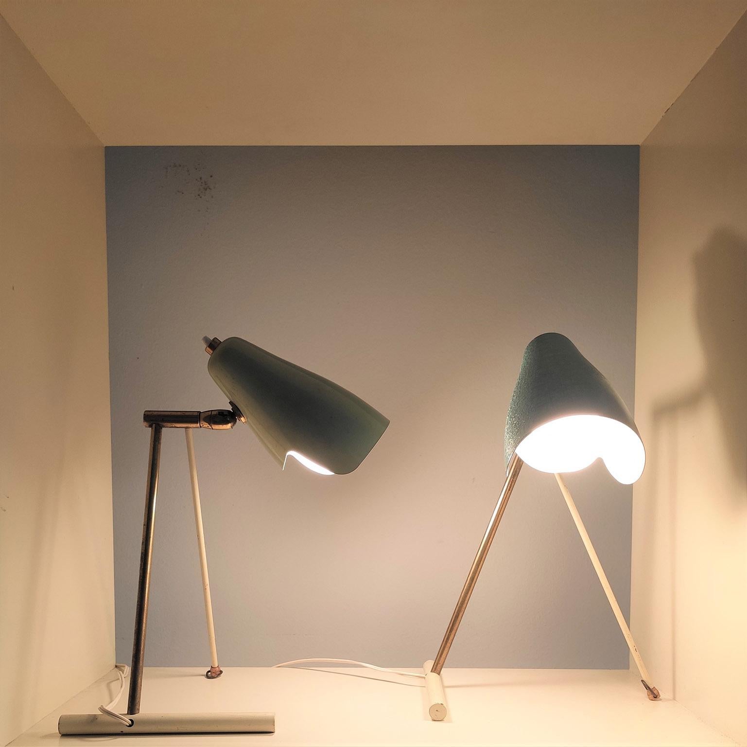 Rare pair of table and /or wall lamps manufactured and Disegned by Stilnovo in the 1950s , the Brass stem support adjustable reflectors in light green lacquered and Light Blue.

It can be hanged to the wall as simply used on a table.
General very