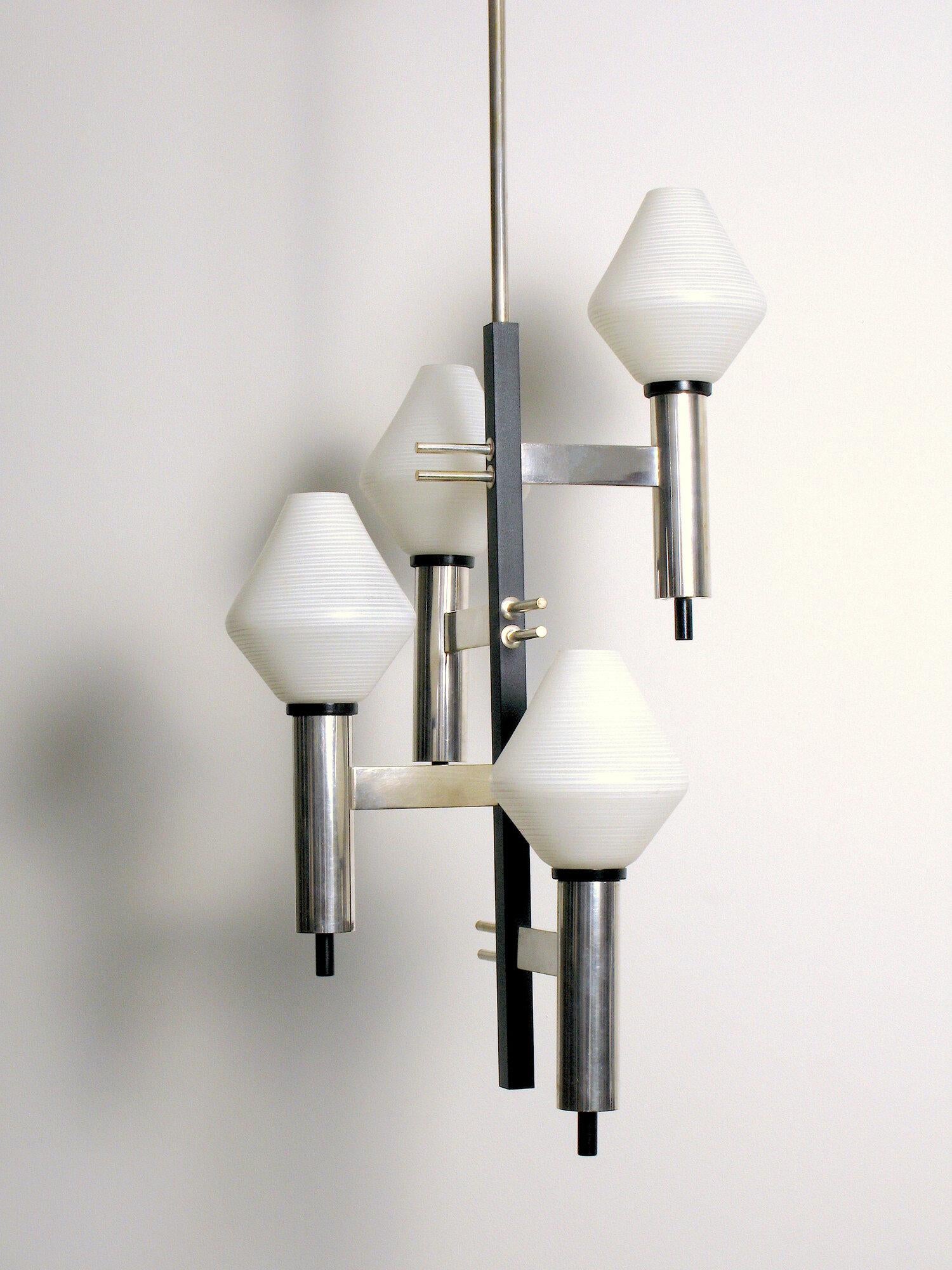 Four light silver chandelier manufactured in the 1950s and attributed to Stilnovo. Enamelled brass body, silver plated brass fittings, etched glass globes, silver plated steel stem.

Partially rewired with new E-12 candelabra base sockets.