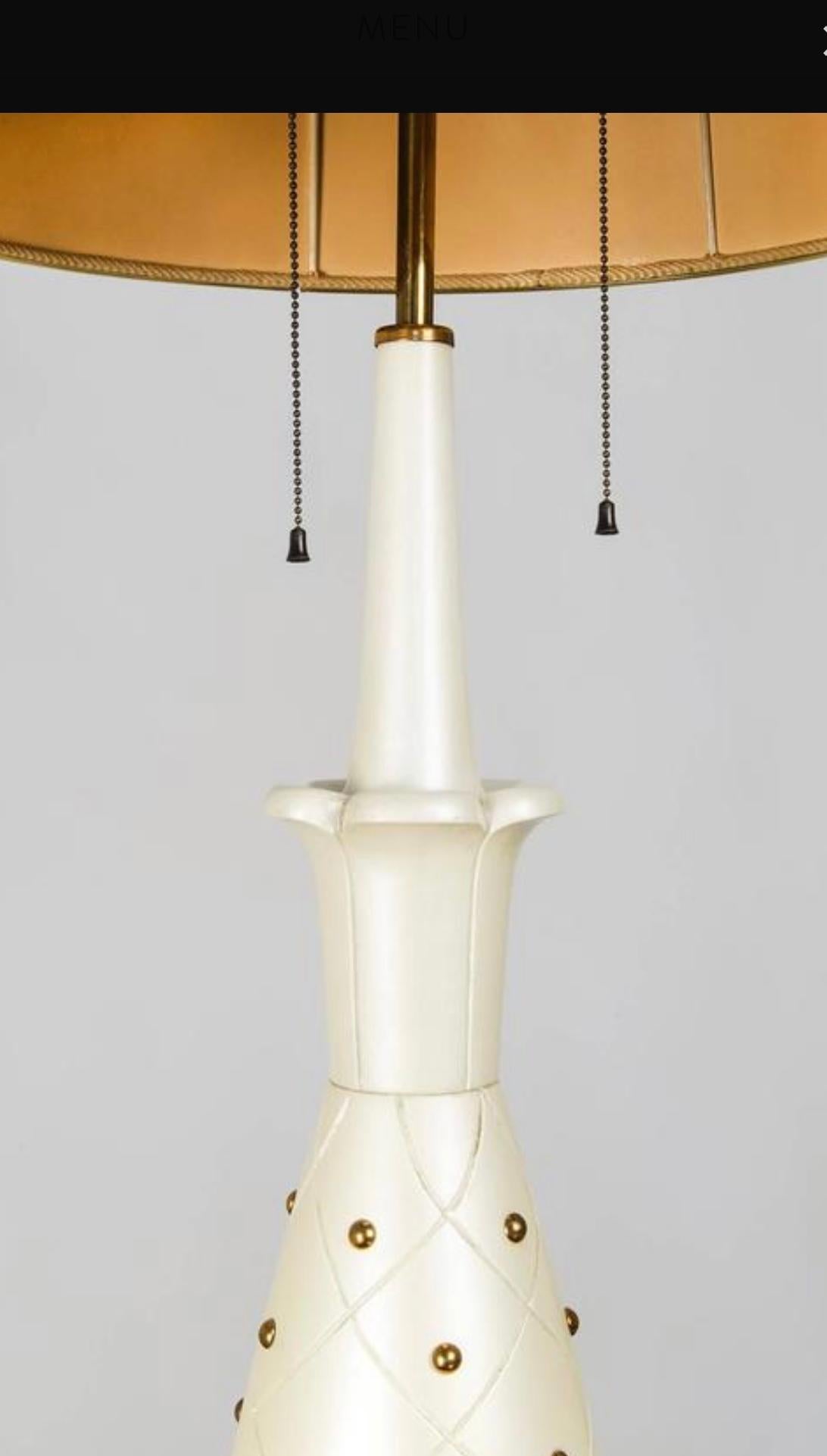 Circa 1950s attributed to Stilnovo pearlescent enamelled tall table lamp in carved wood and brass detailing depicting a pineapple. It has 2 light fixtures each operated by a brass pull switch. 



