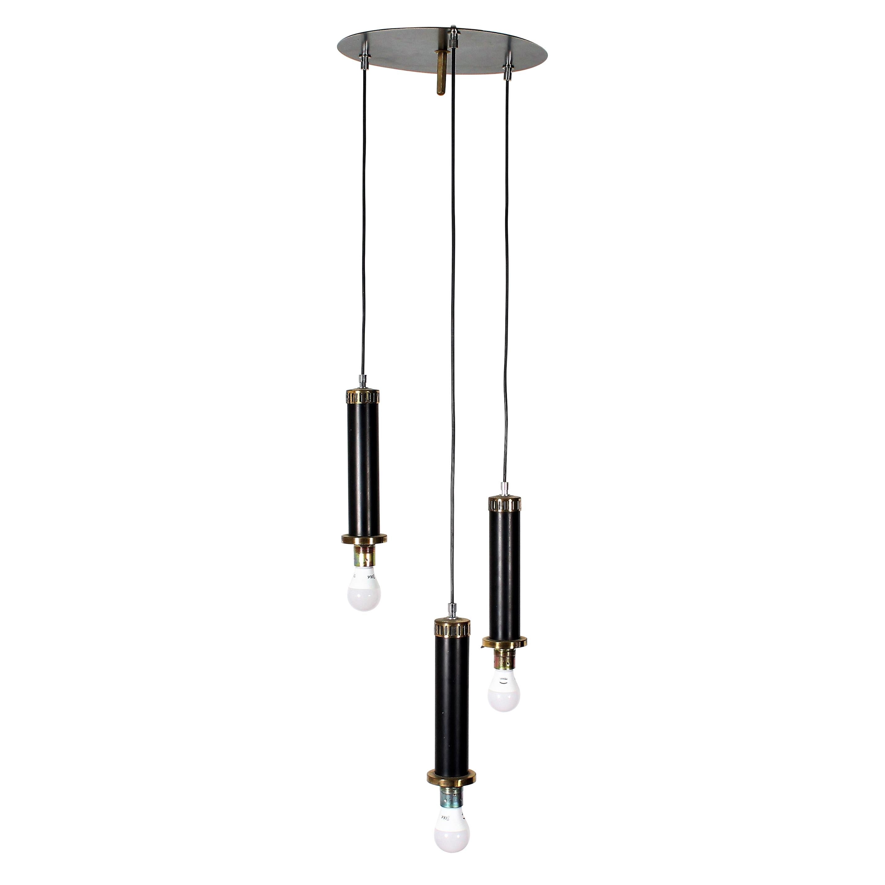 Suspension lamp with three pendants and opal glass, made of black metal supports and brass finishes. Stilnovo style Italian production, 1960.
 