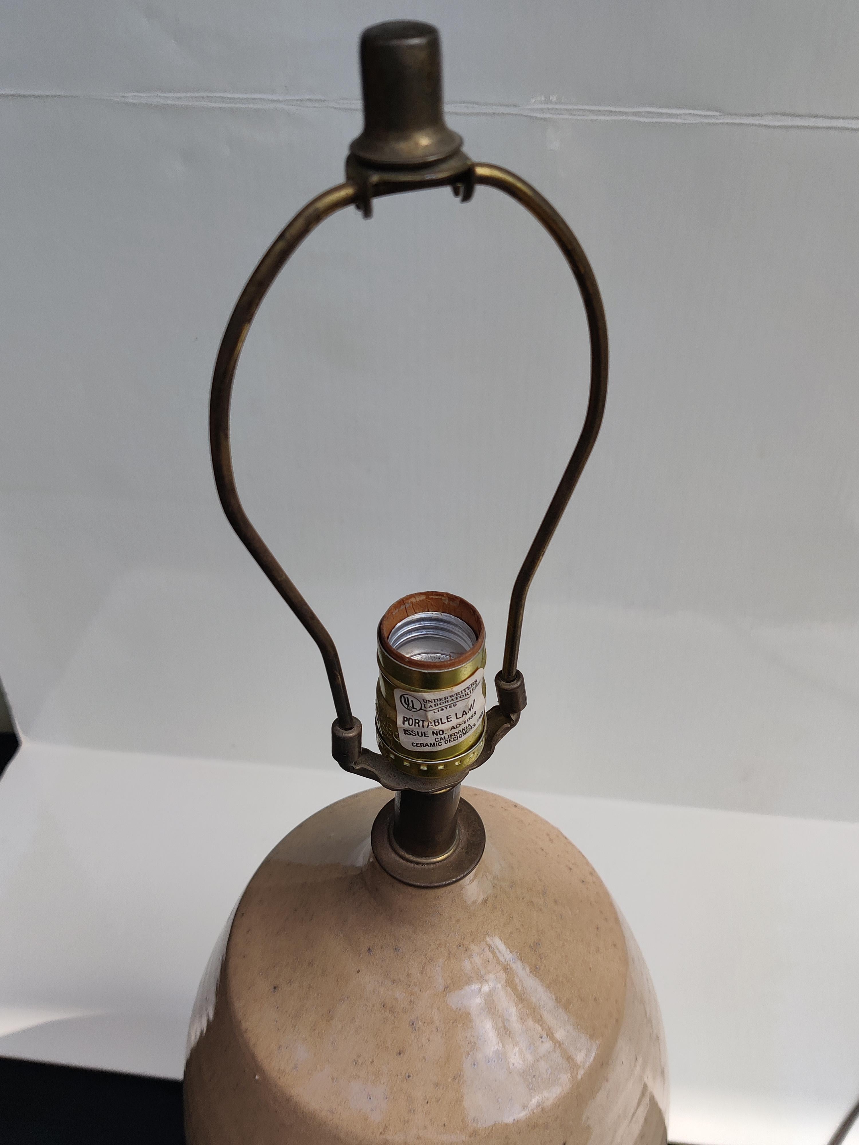 Mid Century Stoneware Lamp.
Made by California Ceramic Designer. 
Stoneware incised pattern.
3 way socket.  Manufacturer mark on socket. 
Base 7.5