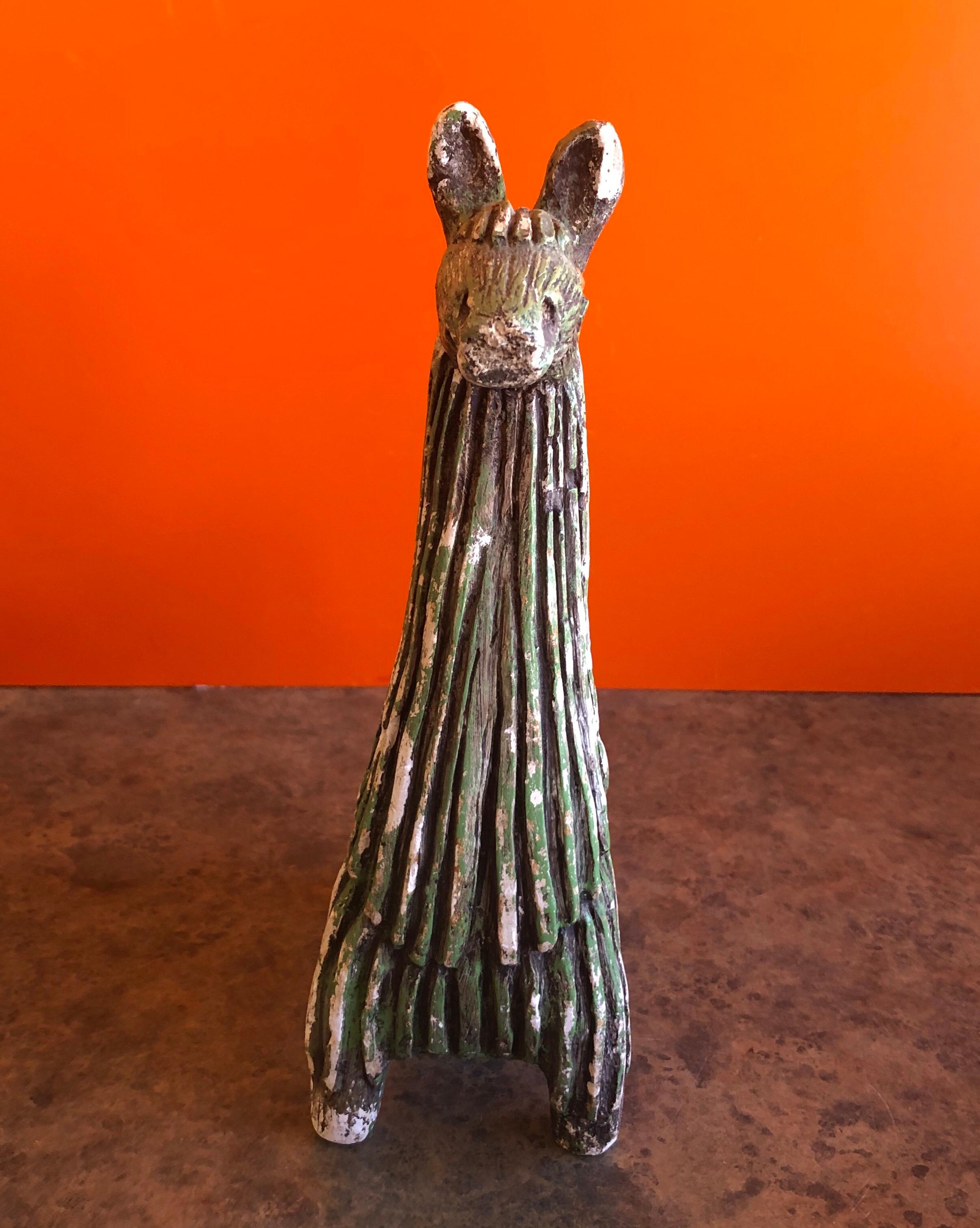 A very cool midcentury stoneware llama by Fabbri Art Co. of San Francisco, circa 1970s. The llama has been beautifully sculpted with deep striking texture in a rich deep greenish color.

The piece stands 10.25