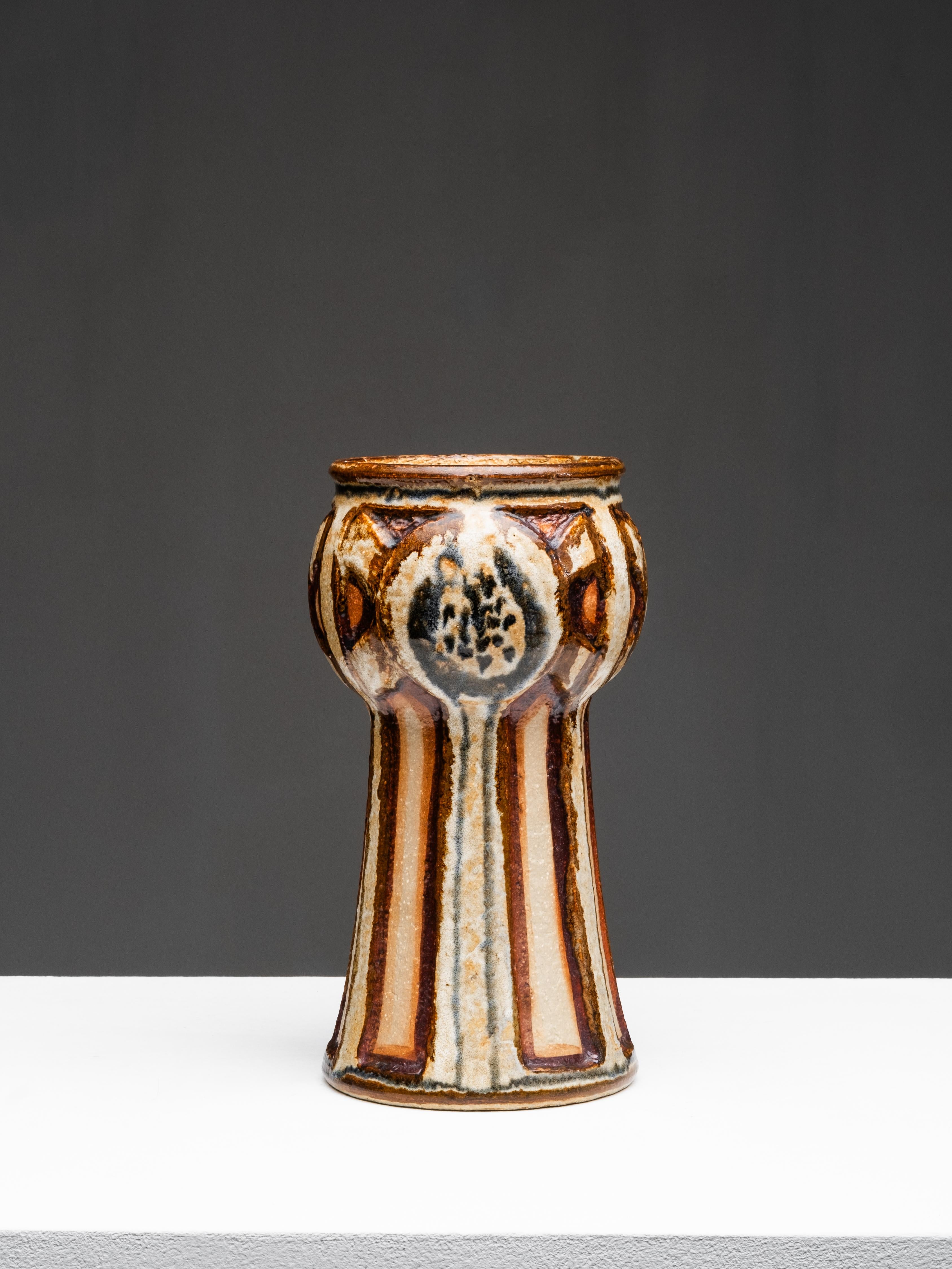 A rare stoneware vase by Søholm Stentøj, handcrafted on the island of Bornholm, Denmark. The piece has a tall, flaring form and hand-painted vertical stripes in layered tones of brown, beige, and slate blue. The glossy surface reveals subtle