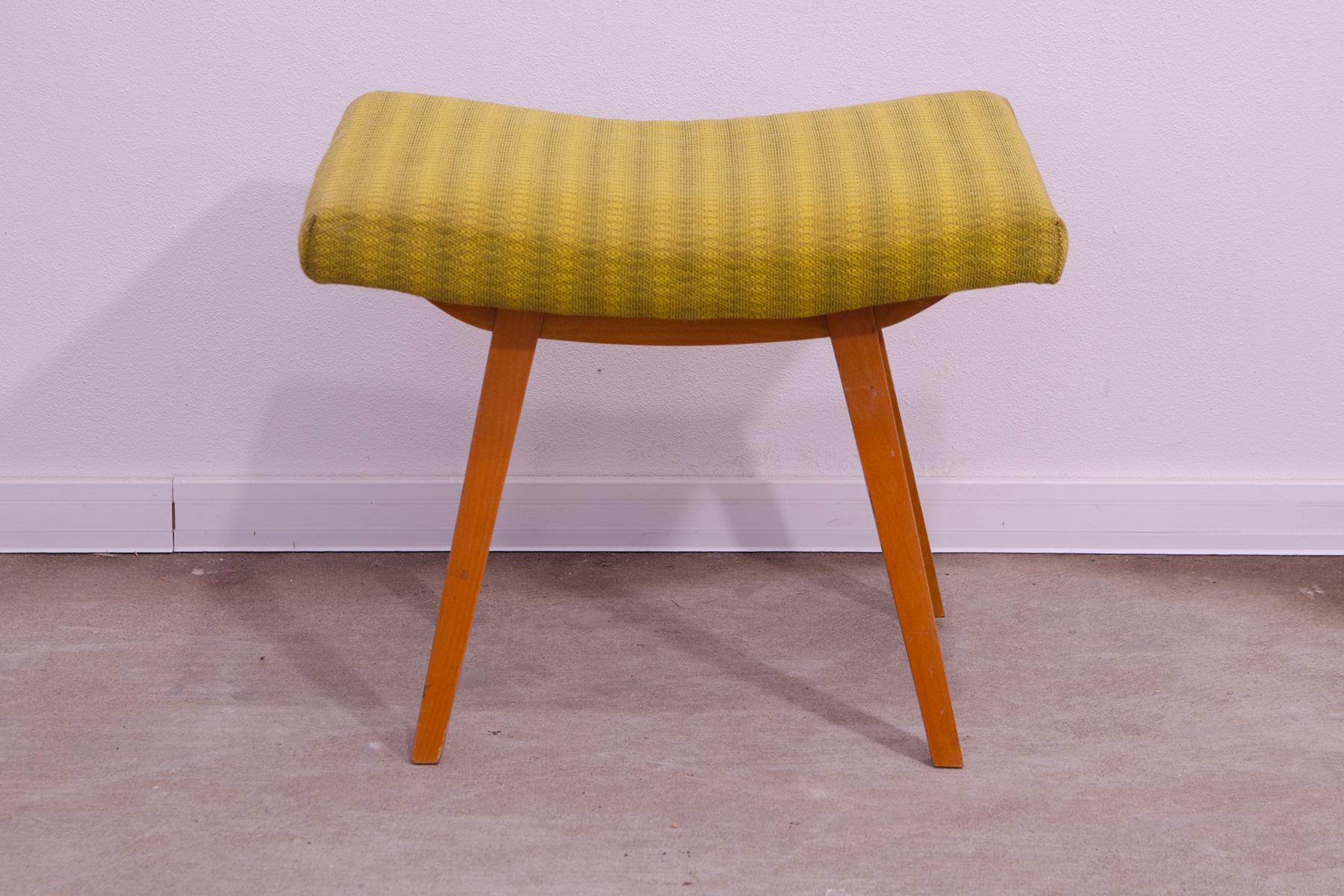 This midcentury  stool/footrest was made by Západoslovenské nábytkárské Závody in the former Czechoslovakia in the 1970´s. It has leatherette seat and the structure is made of beech wood. In good Vintage condition, showing signs of age and
