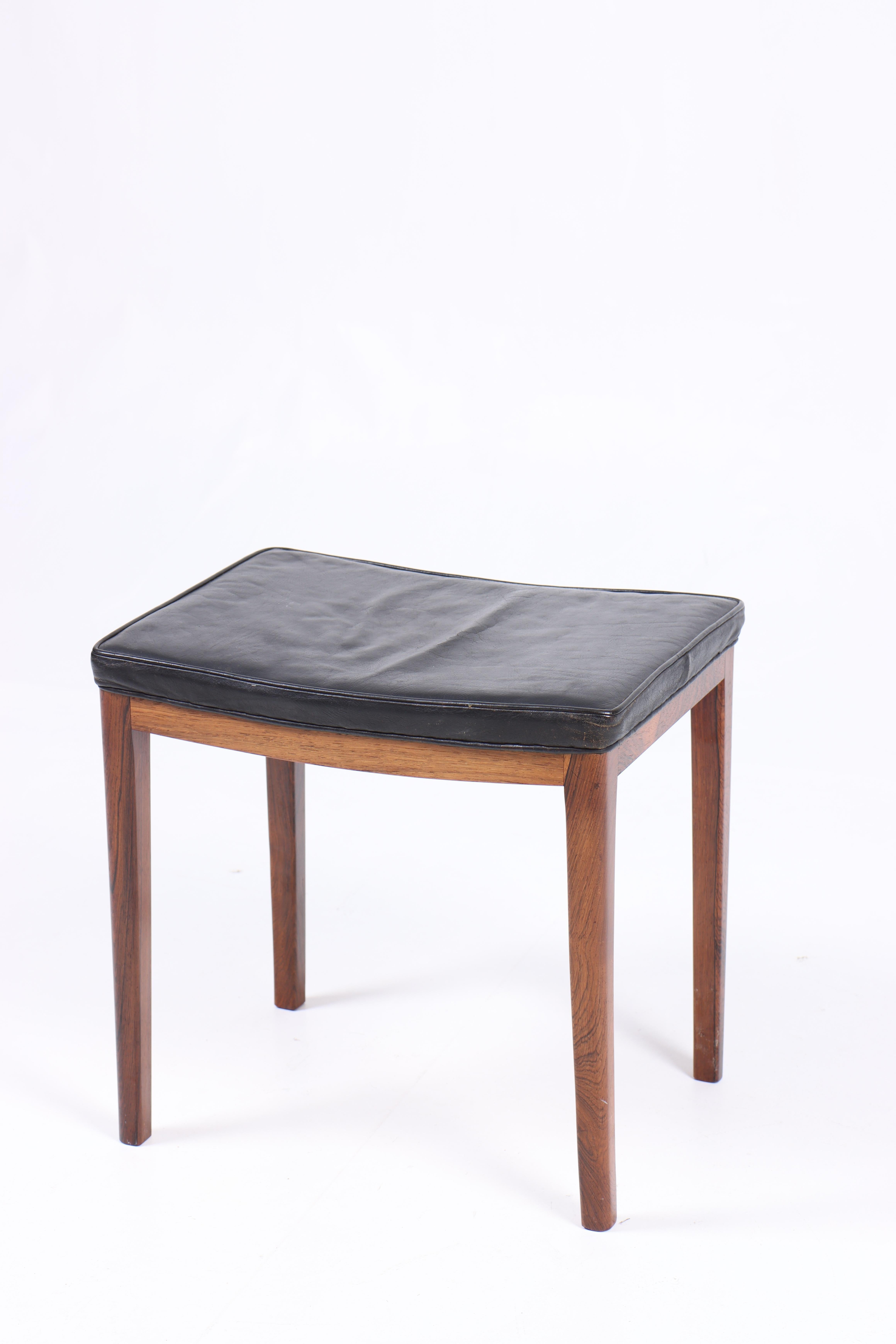 Stool in patinated leather and rosewood frame, designed and made in Denmark.