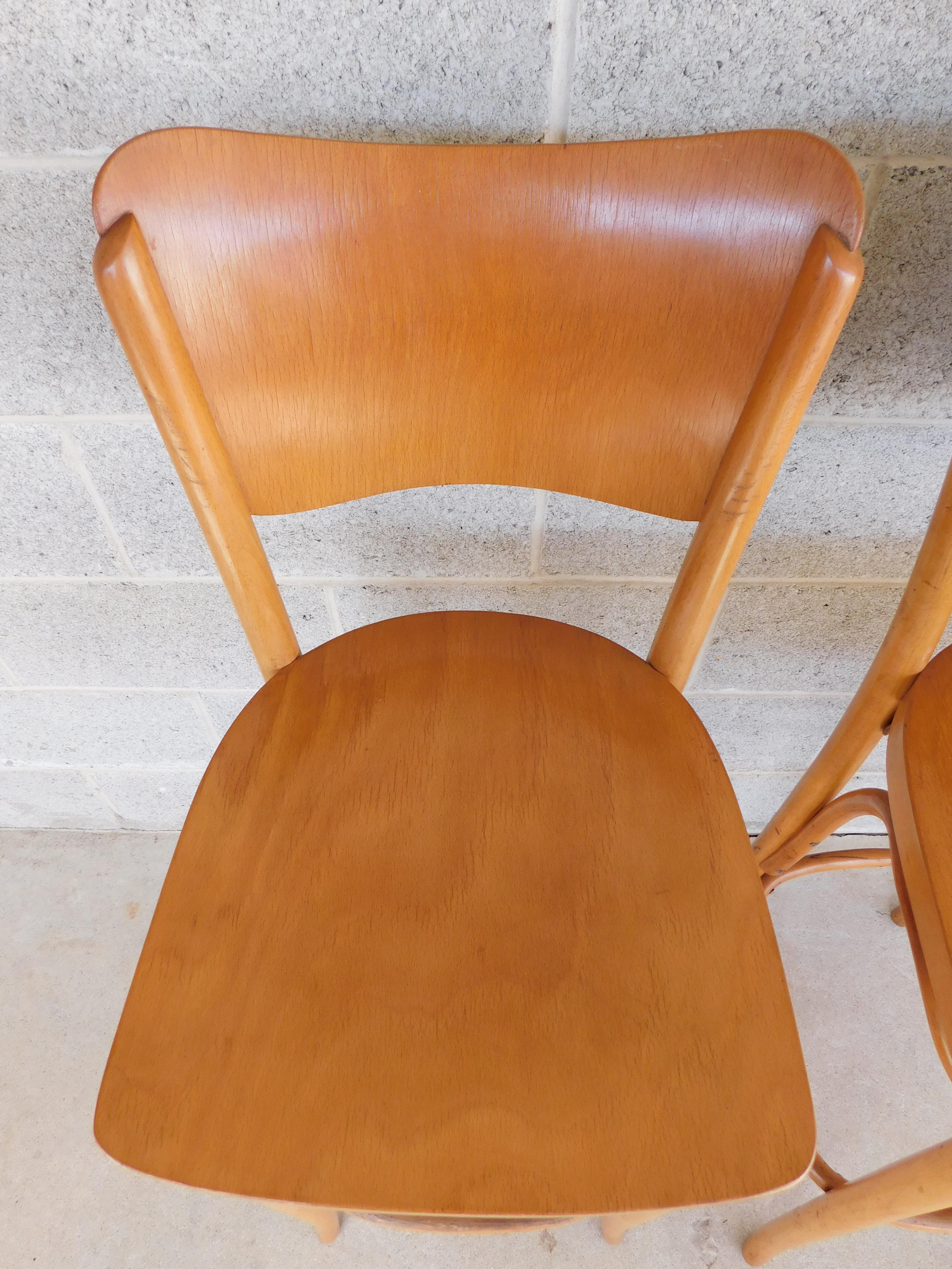 Midcentury design, with bentwood leg center brace support lower foot rest. Back legs extend up through the curved contoured back rest. Attributed to Thonet made in Poland. 

Label is Unrecognizable 

Measures: Back height 42.5