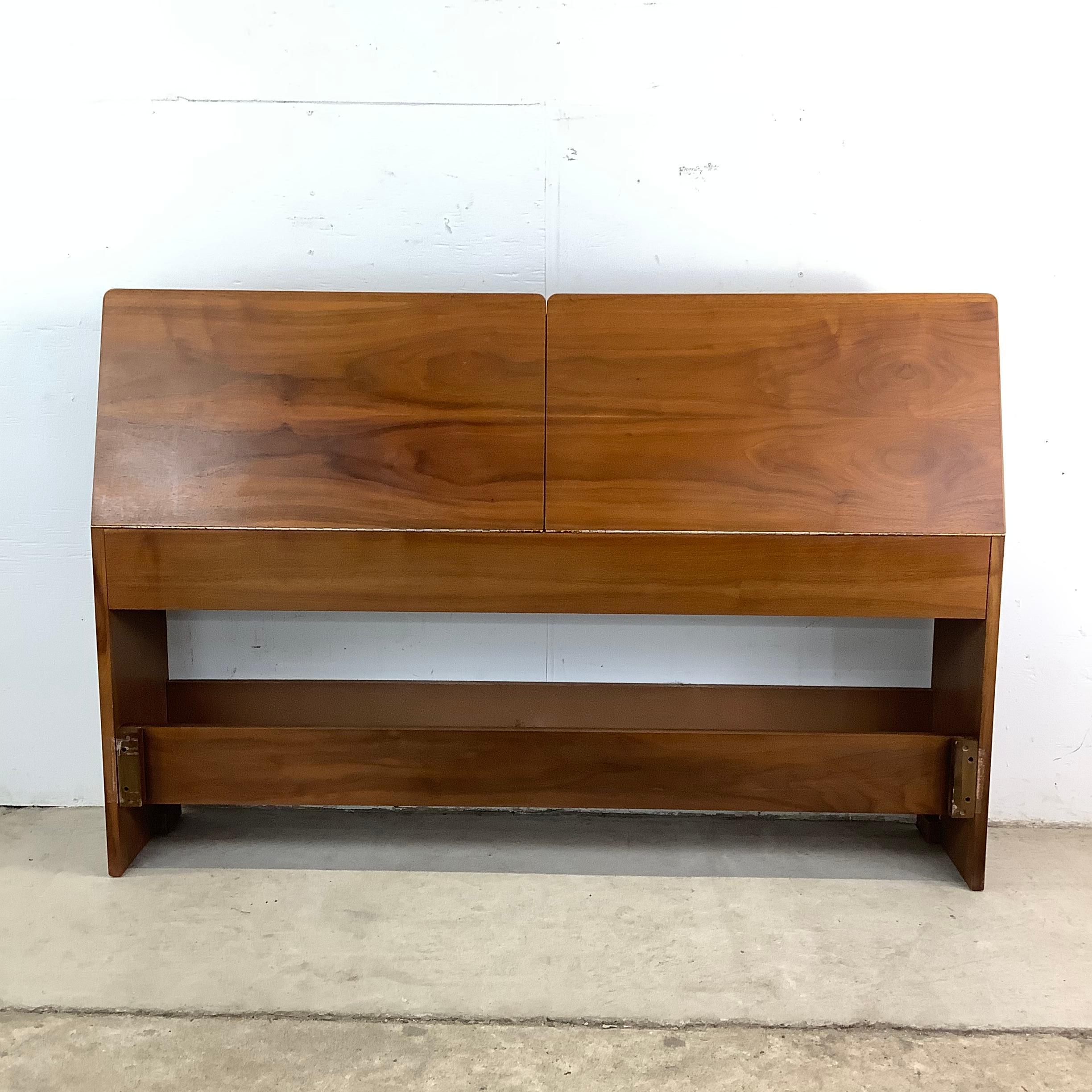 Timeless design meets everyday functionality in this Mid-Century Full-Size Drop Front Storage Headboard, attributed to Kipp Stewart for Drexel Declaration. A masterful blend of beauty and practicality, this piece is crafted from rich walnut, with a