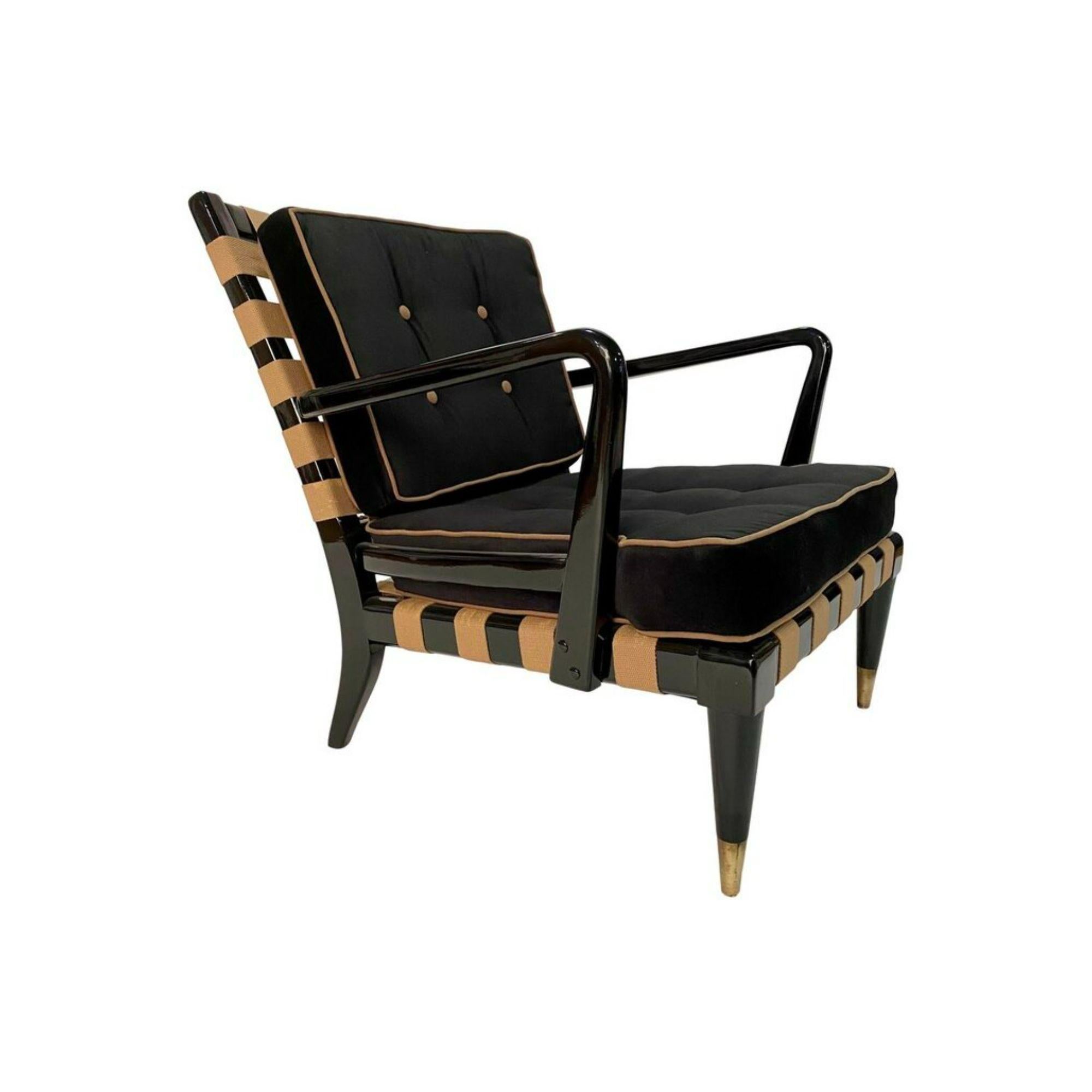 Remarkable mid-century lounge chair in the style of T.H, Robsjohn Gibbings in black lacquer sculptural wood frame with criss cross straps, bronze nail heads in the back, newly upholstered removable cushions with contrast welt and tufting and brass