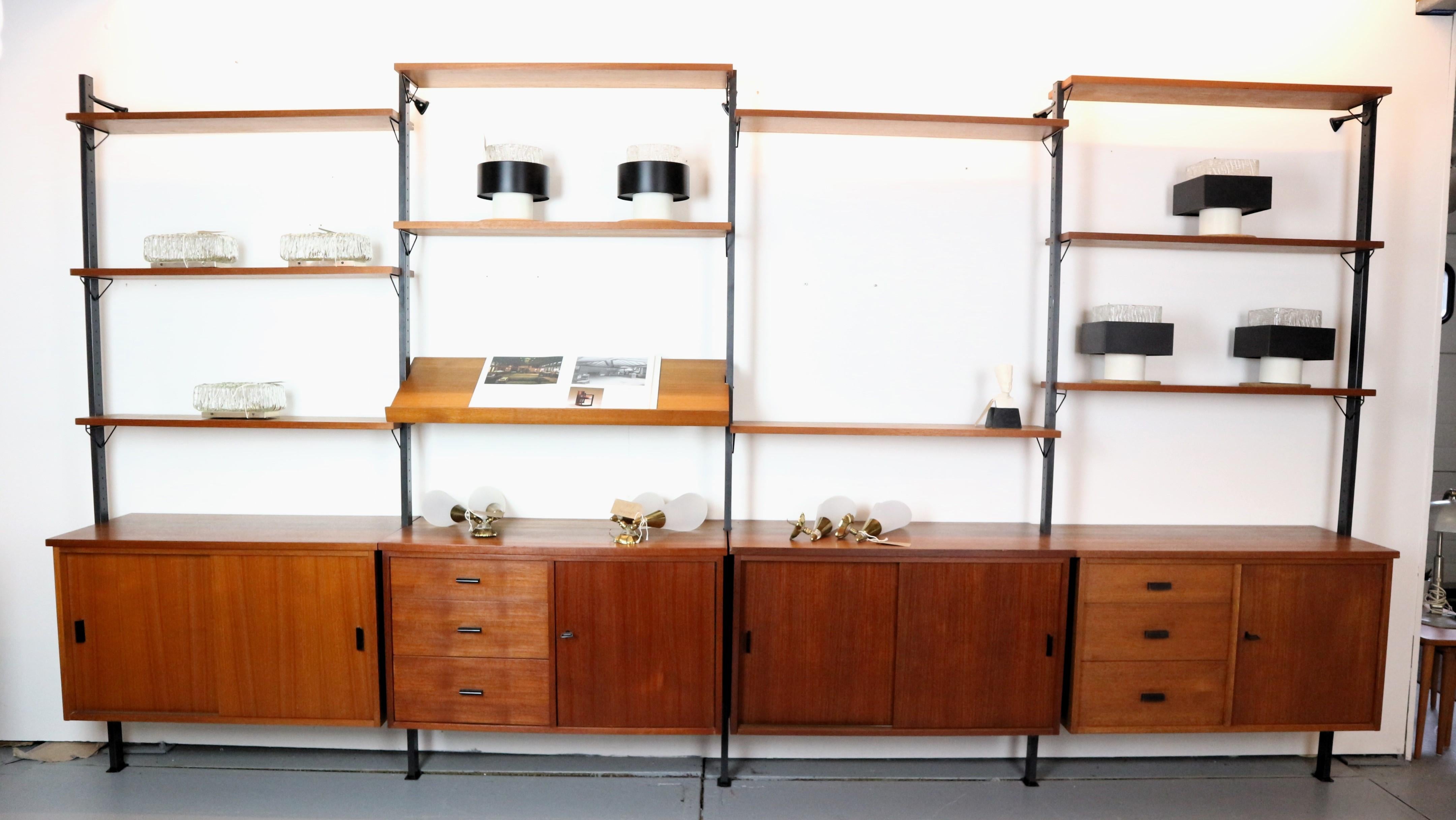 A large  1960s modular shelving system ‘Pira’ designed by Olaf Pira for string of Sweden, made of teak and steel.
The piece is a large modular wall system with five wall brackets, four storage cabinets and 11 shelfs. The individual elements of the