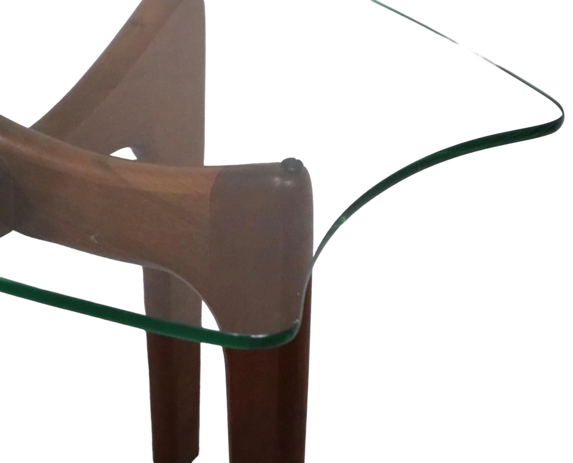 Classic Adrian Pearsall Stingray side, or end table, having its original shaped glass top, on its original  sculpted solid walnut base. This example is in very fine untouched condition, showing only light cosmetic wear, normal and consistent with