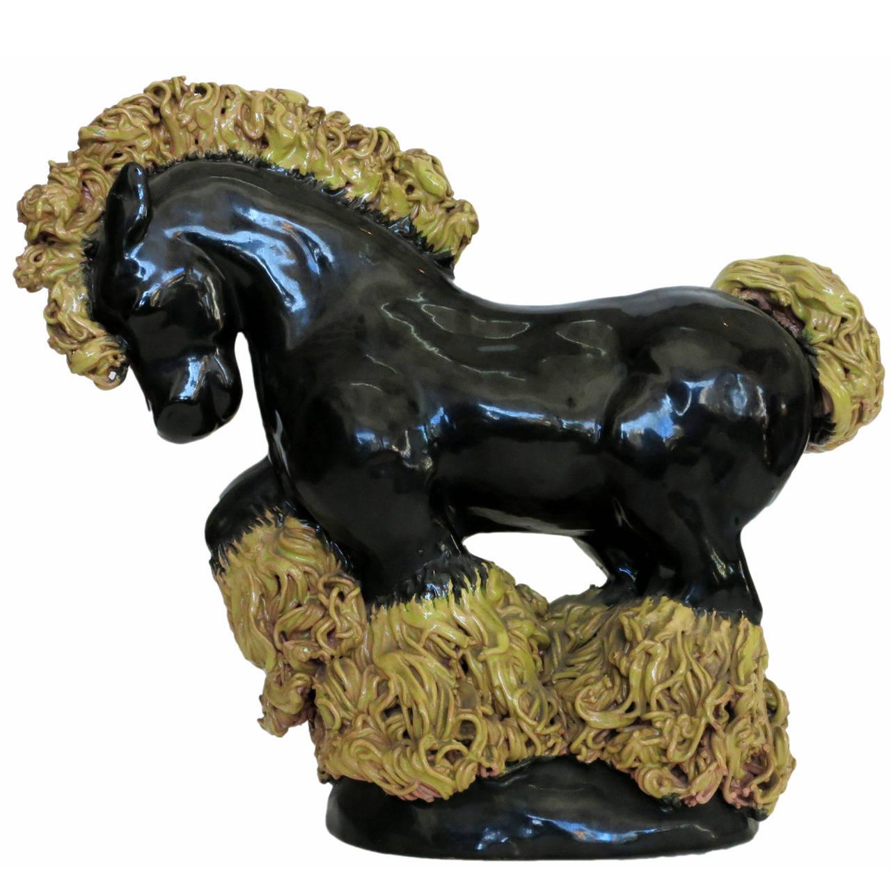 Wonderful studio art pottery horse in a dressage pose with jet black coat and golden mane and horse feathers. 

This wonderful studio art pottery horse was made by a Los Angeles Pottery Studio during the 1950s. A very unique, finely crafted piece