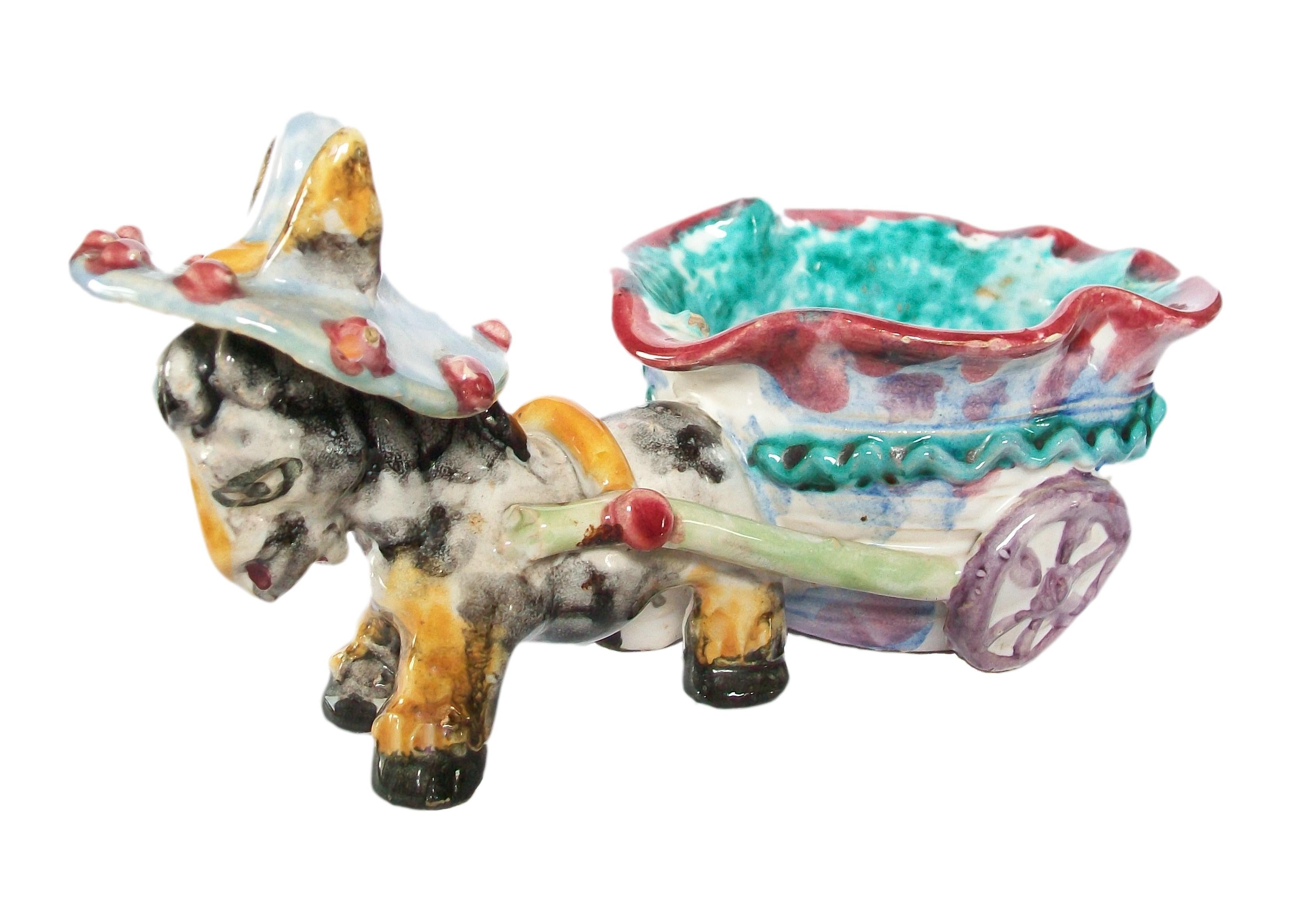 Mid Century studio pottery donkey and cart figure / bowl - hand modelled and painted with vibrant multi-color glazes over a cream base - signed & numbered on the base (unknown / unidentified potter / studio) - Italy - circa 1960's.

Excellent