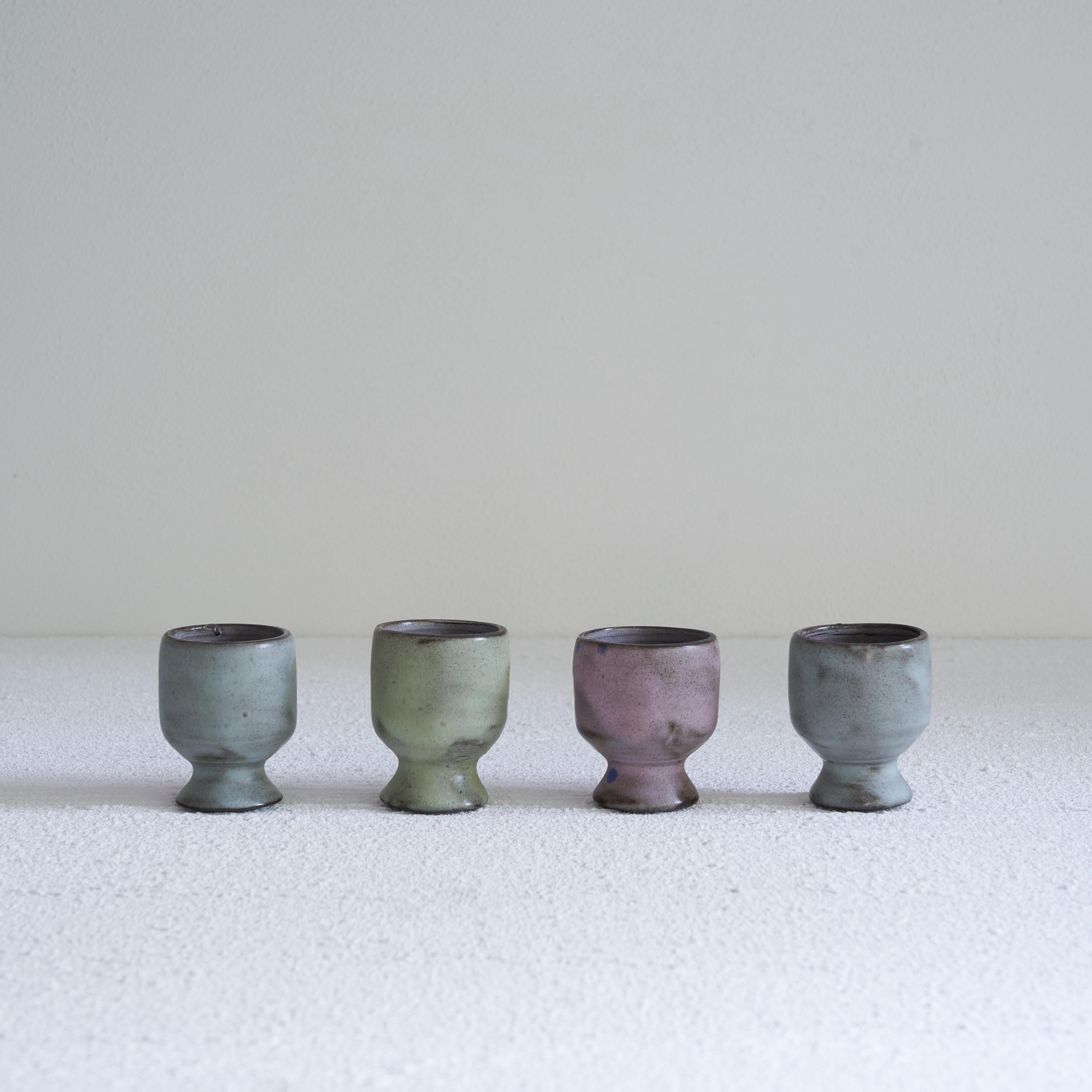 Mid Century Studio Pottery Egg Cups Set of 4. Mid 20th century.

Great set of 4 mid-century studio pottery egg cups. Hand made and wonderful in color, design and appearance. Every one has a different color, ranging from purple to green and blue.