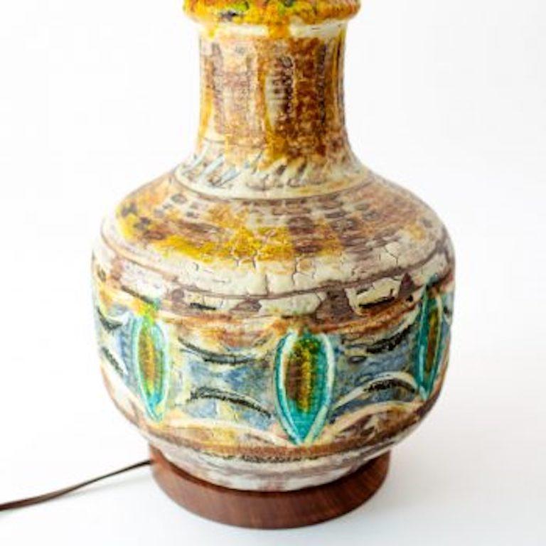 Exceptional American studio glazed and polychromed pottery lamp with incised decoration to the body. Lavender, yellow, turquoise, blue. Turned walnut accents. New linen silk shade and rewired with brown nylon cord.