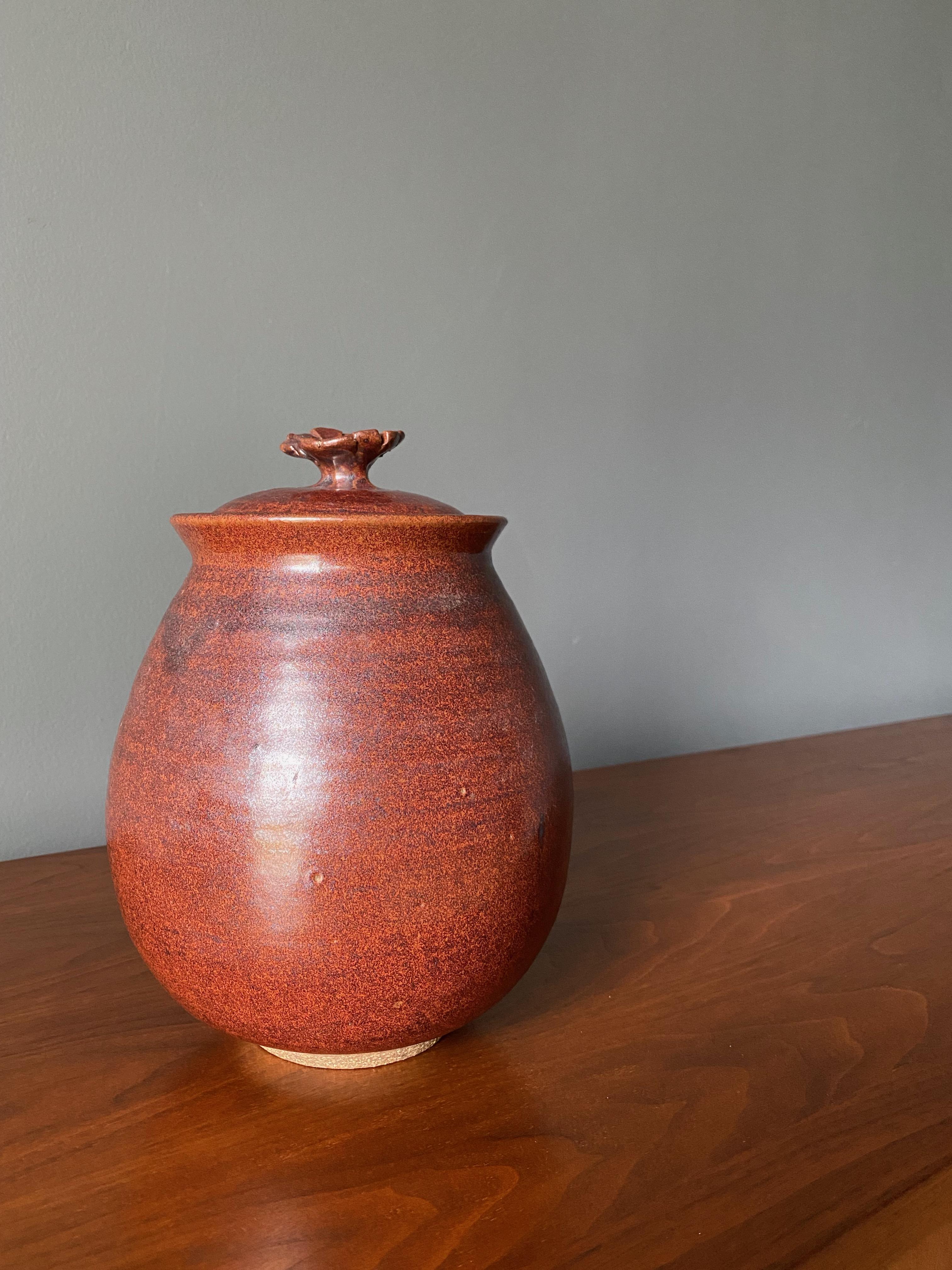 Vintage studio pottery. Ceramic jar with lid. Beautifully and thoughtfully crafted with a uniquely shaped handle.