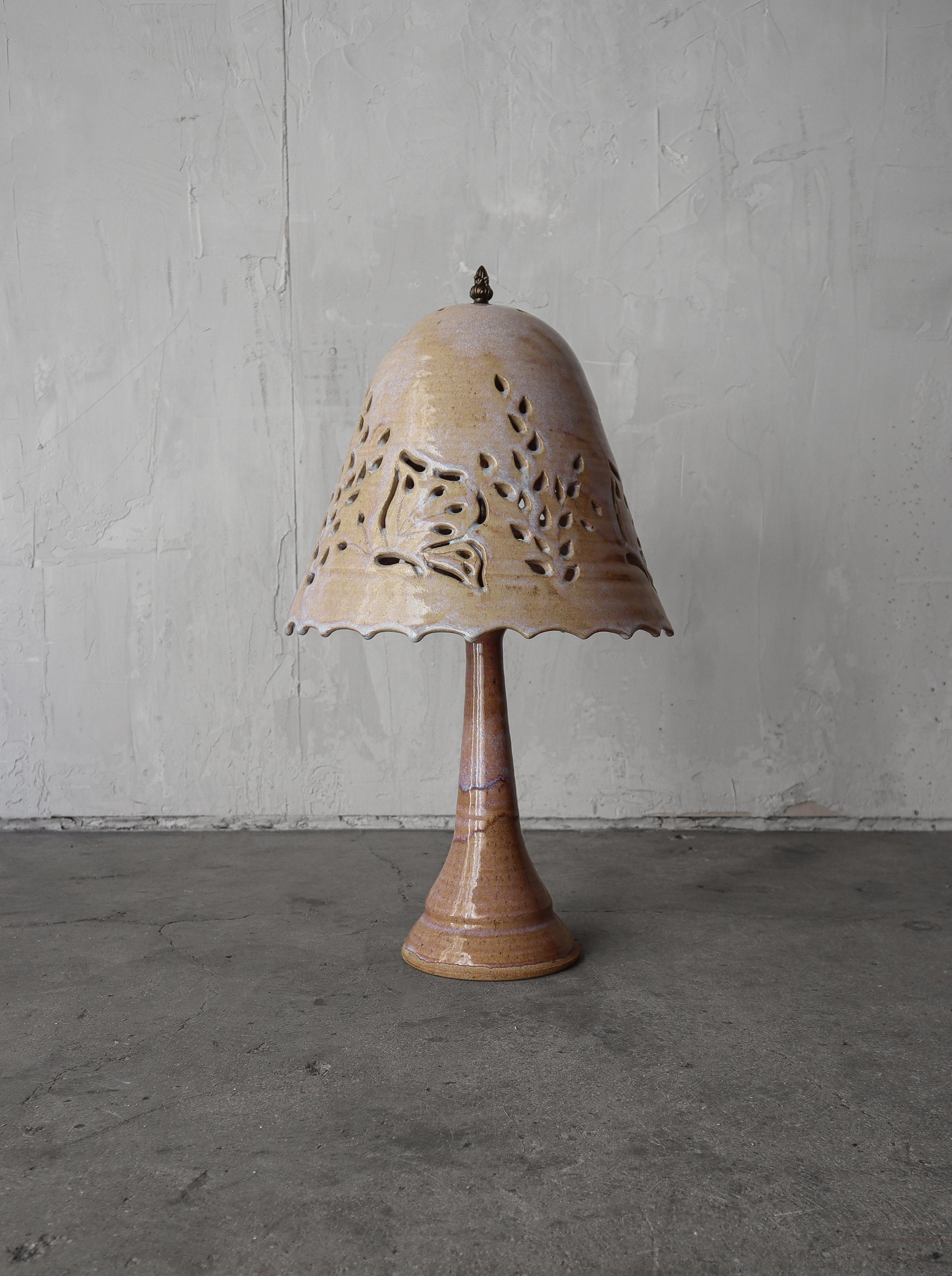 Magnificent hand crafted Studio Pottery table lamp.  Lamp base and shade are all glazed stoneware.  The lamp features a pierced shade that allows the lamp to cast the most beautiful light and shadows.  Such a warm beautiful piece.

Lamp is in