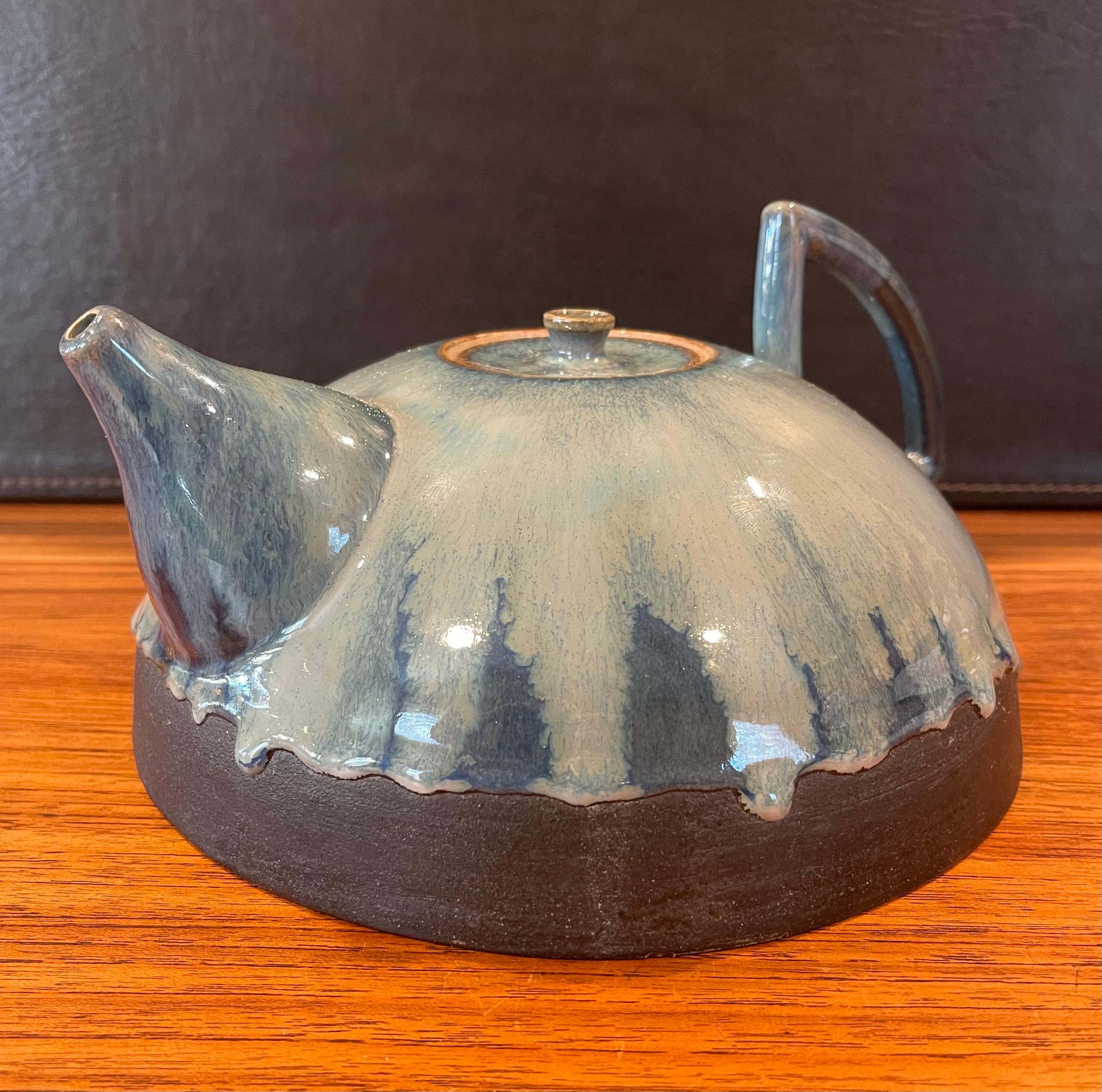 Mid-century studio pottery tea pot with blue lava glaze, circa 1970s. The pot is in very good vintage with no chips or cracks and measures 11