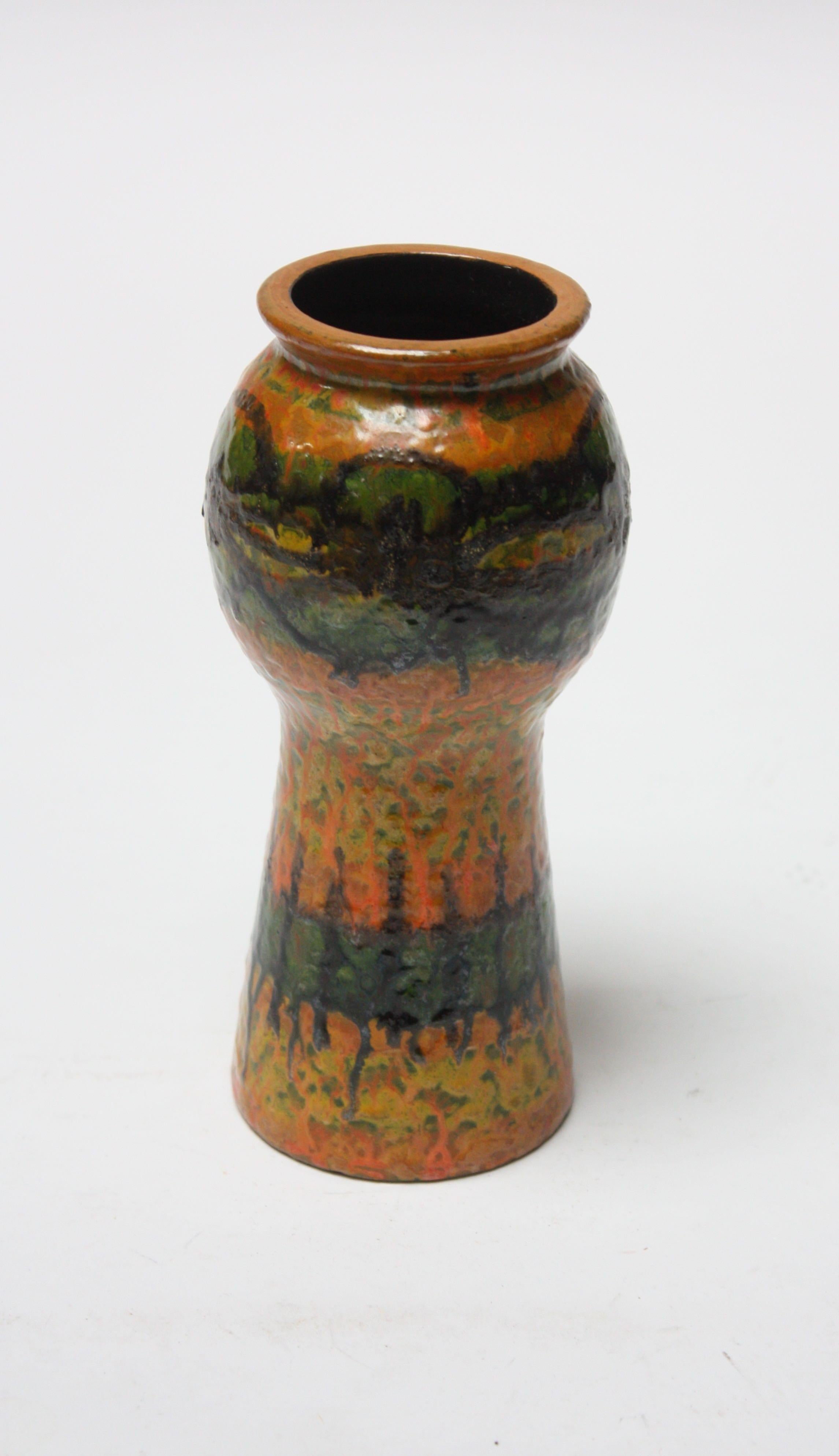Small scale studio ceramic vase circa 1960s (likely Italian but unmarked). Stylish pattern and attractive, bold colors in green, ochre, orange, yellow, and black.
Measures: Diameter 3.25