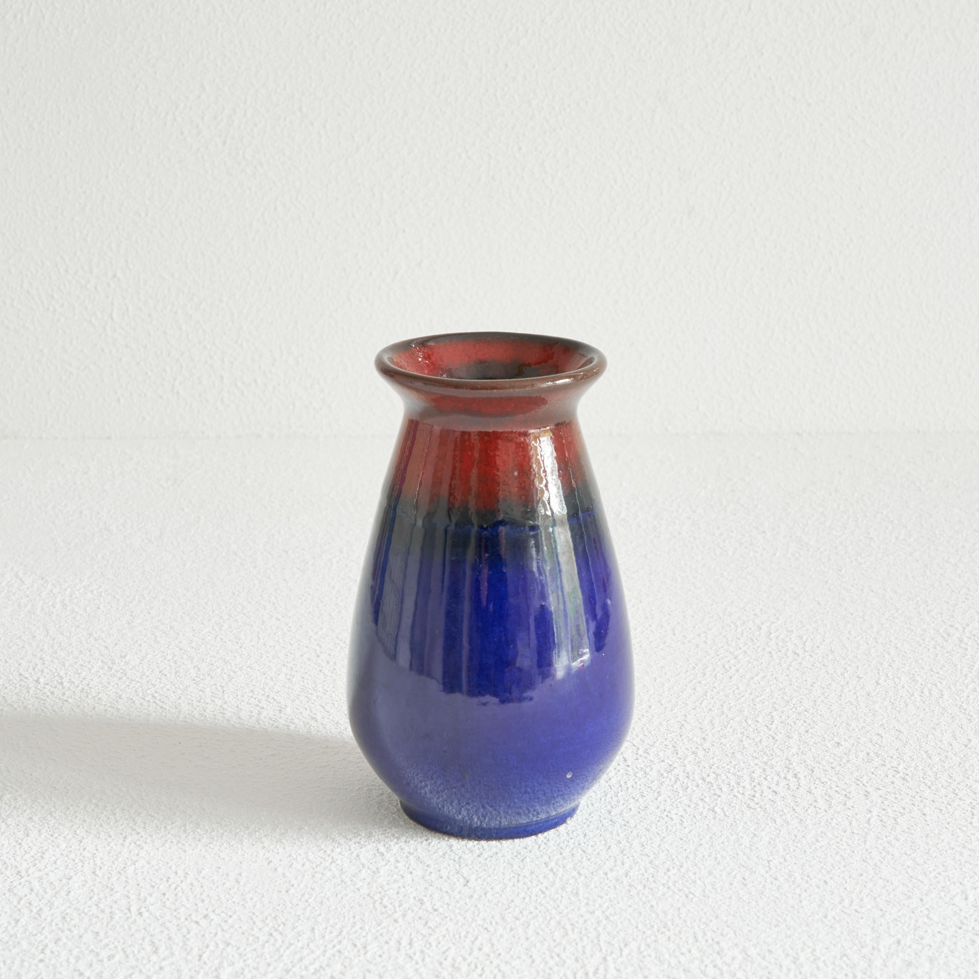 Midcentury Studio Pottery Vase by Jasba Keramik, Germany, 1960s.

Wonderful and colorful West Germany Studio Pottery vase by Jasba Keramik. Great deep colors, shifting from blue to red with a very stylish shiny glaze. 

Featuring a simple but