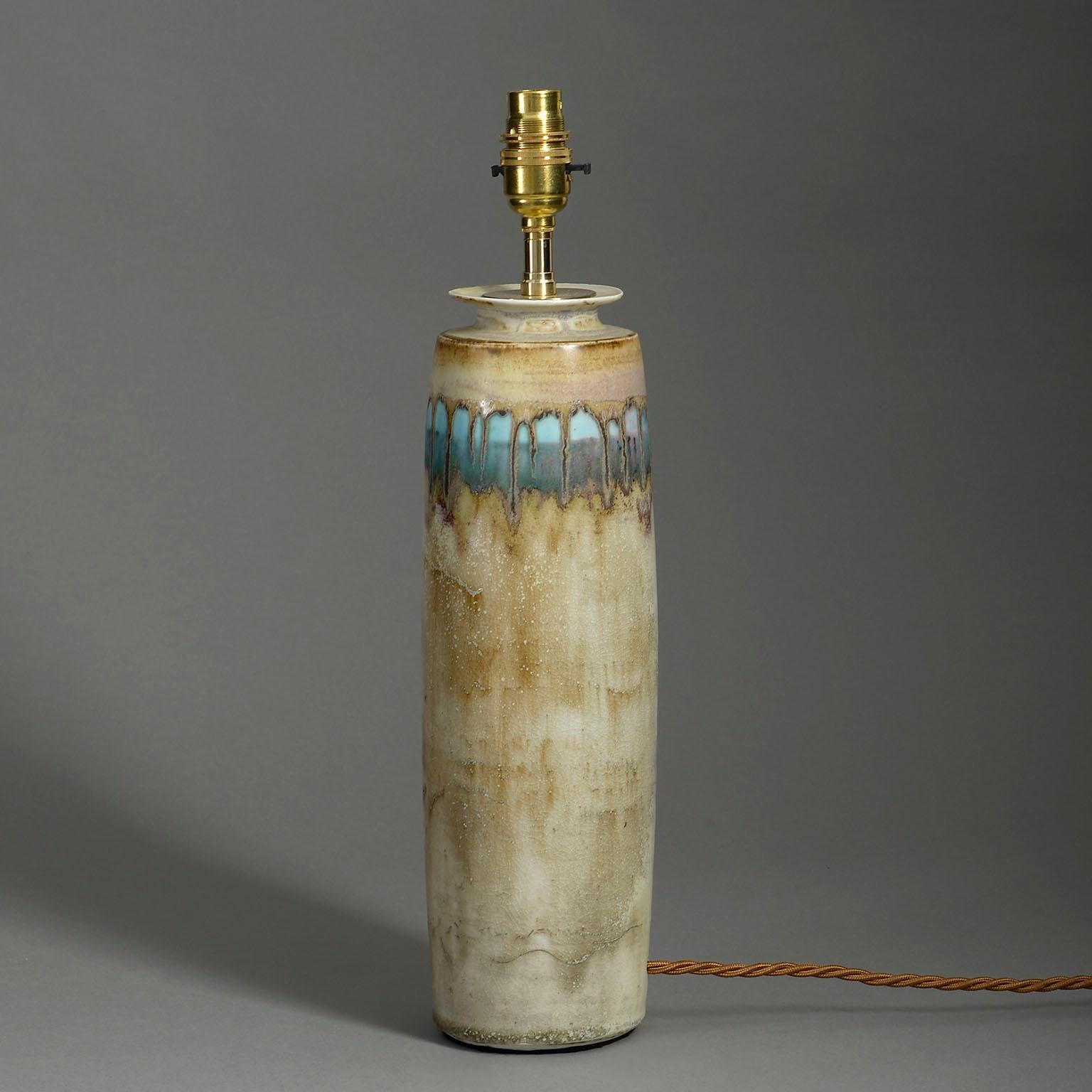 A mid-twentieth century studio pottery vase of cylindrical form, with turquoise glazed collar upon a caramel ground. Now mounted as a lamp.

Dimensions refer to ceramic vase part only.

Wired to UK standards. This lamp can be rewired to all