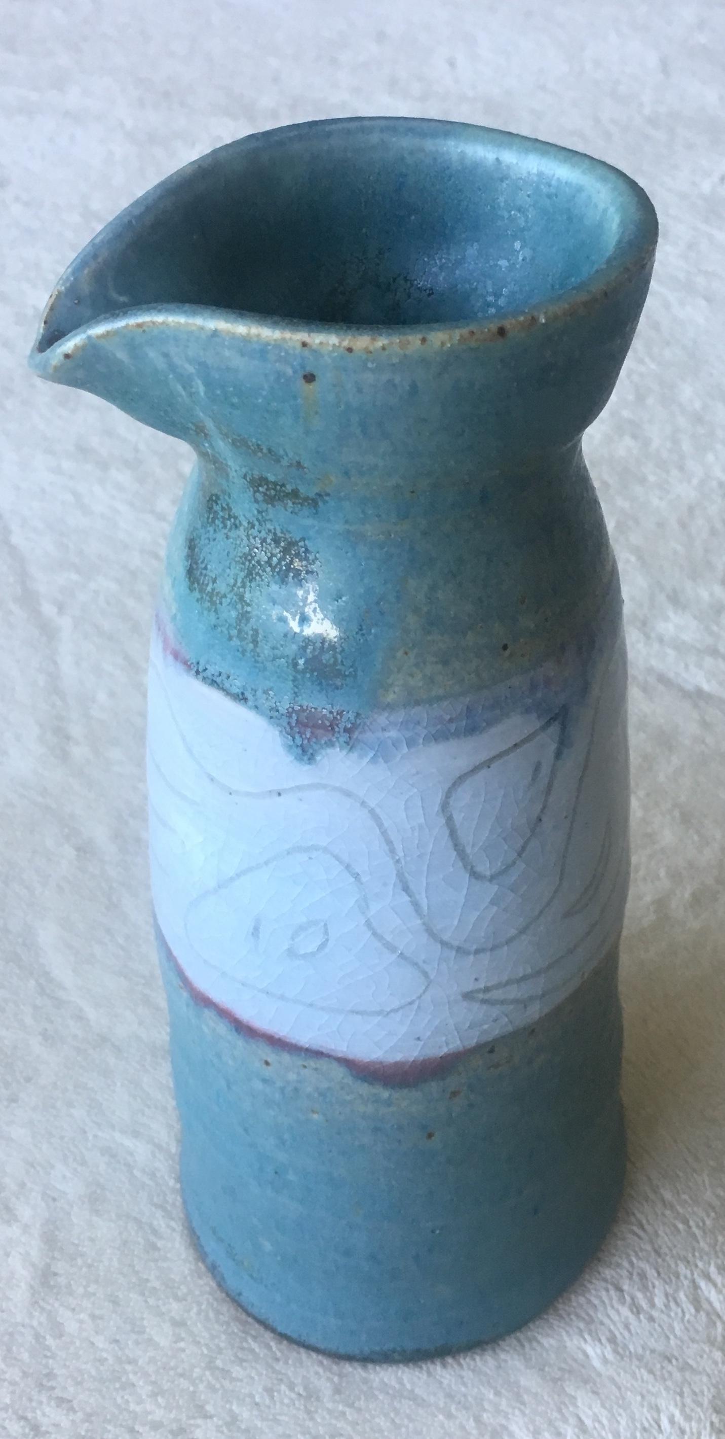Beautiful glazed decorated, stylized and graphic design vase revealing a contrasting matte blue green underglaze. 

Unique handcrafted piece. 
Signed.