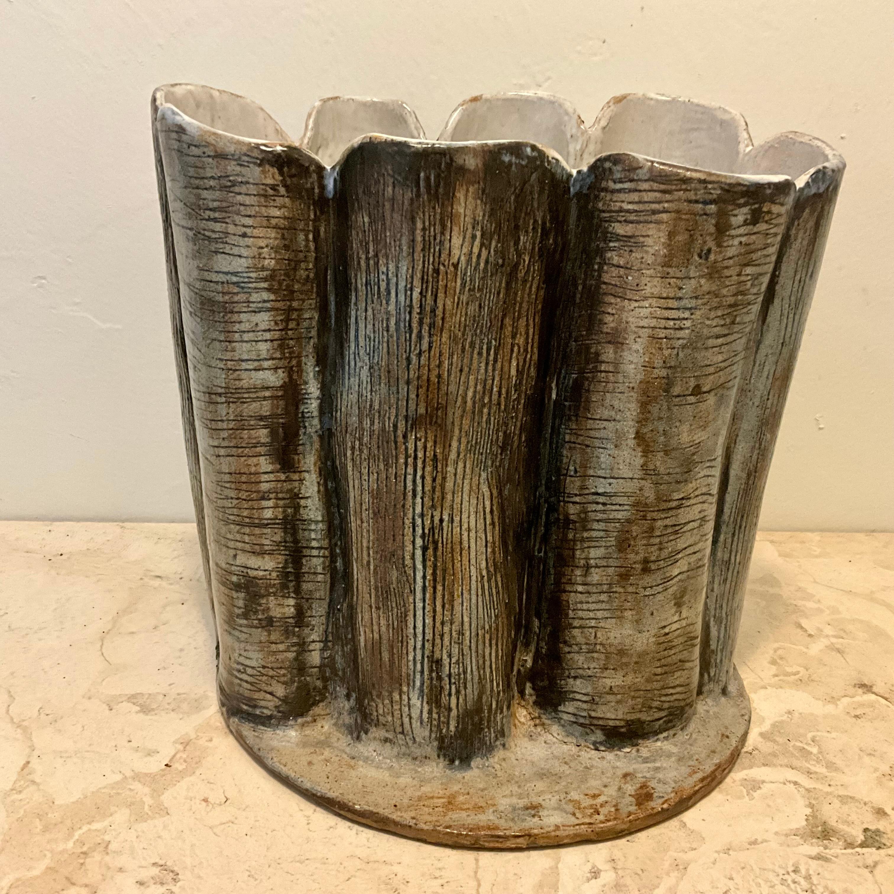 Title:
Mid-Century Studio Pottery Vessel with Sculptural Faux Tree-Bark  

Description:
Handcrafted mid-century ceramic vessel with an organic, sculptural design reminiscent of tree bark or woodgrain. The cylindrical form is fluted with irregular