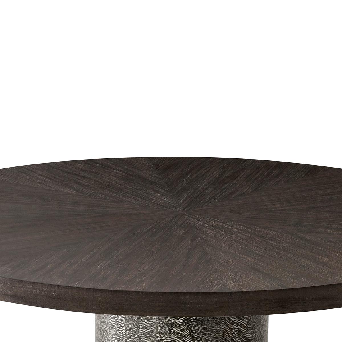 with a sunburst inlaid rowan primavera veneered circular top raised on a cylindrical column pedestal wrapped in Tempest embossed leather, with brass accents and a veneered platform base.

Dimensions: 60 