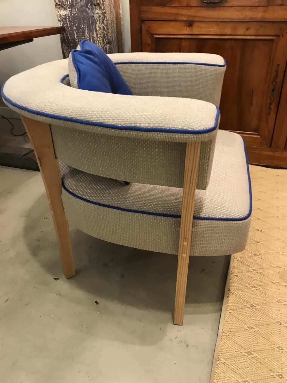 Called the “Viking Chair,” this unique Mid-Century Modern style armchair will be a fabulous addition to your sitting room. This chair is deceivingly comfortable. Styled after a 1960s Danish design, it is upholstered in natural linen with blue piping