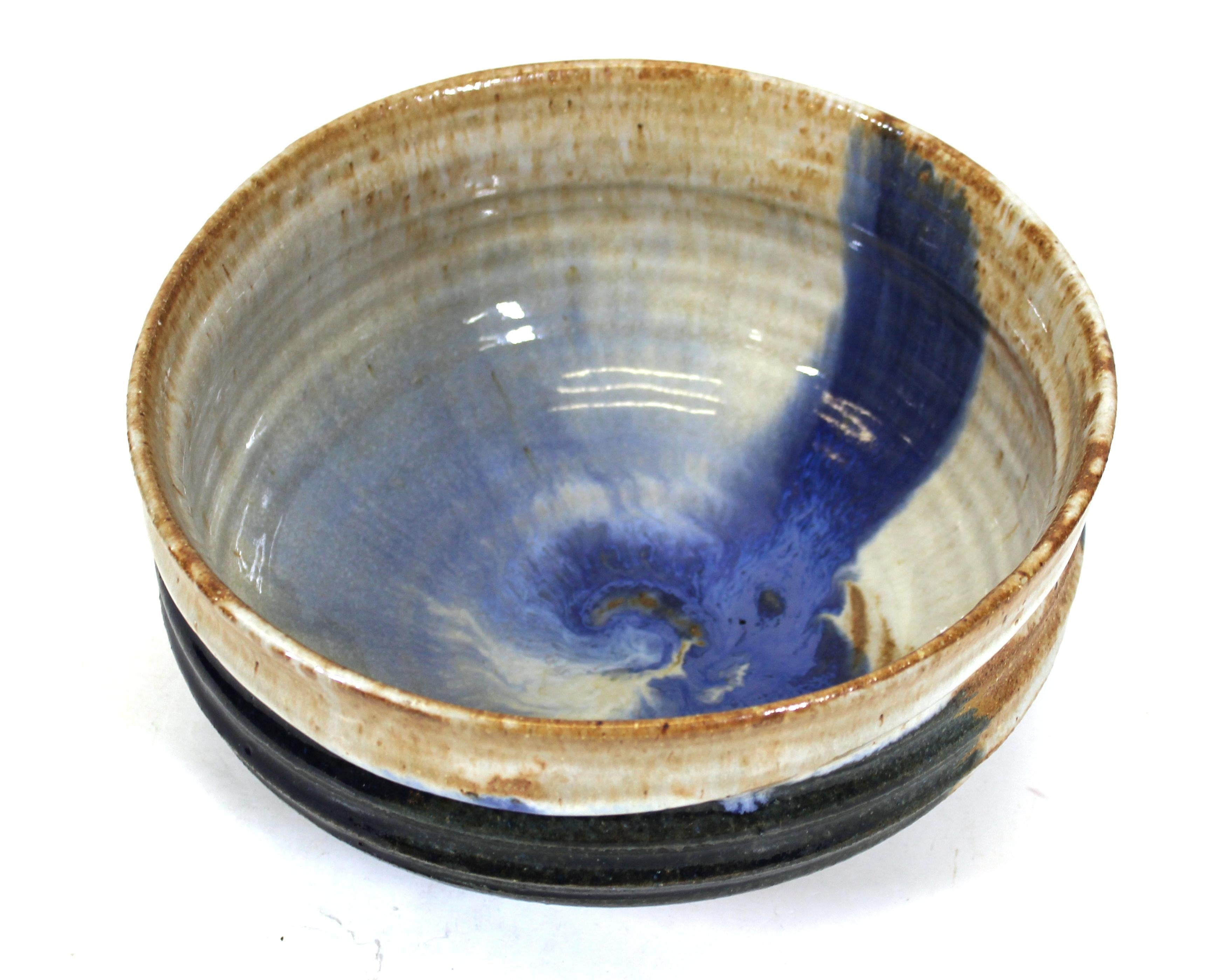 Mid-Century Modern style art Studio Pottery bowl with blue and white glaze, signed illegibly on the bottom.