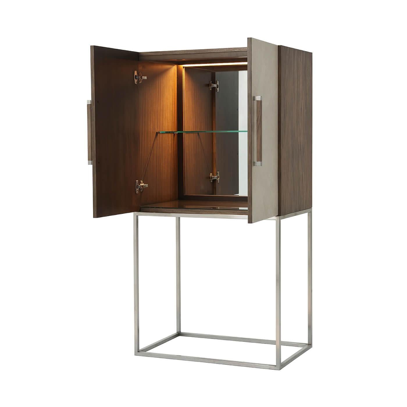 Midcentury style leather-wrapped bar cabinet with a primavera veneered case in our mangrove finish with overcast finish starburst komoda embossed leather doors, with square baton handles with polished nickel finish clasps, polished nickel finish