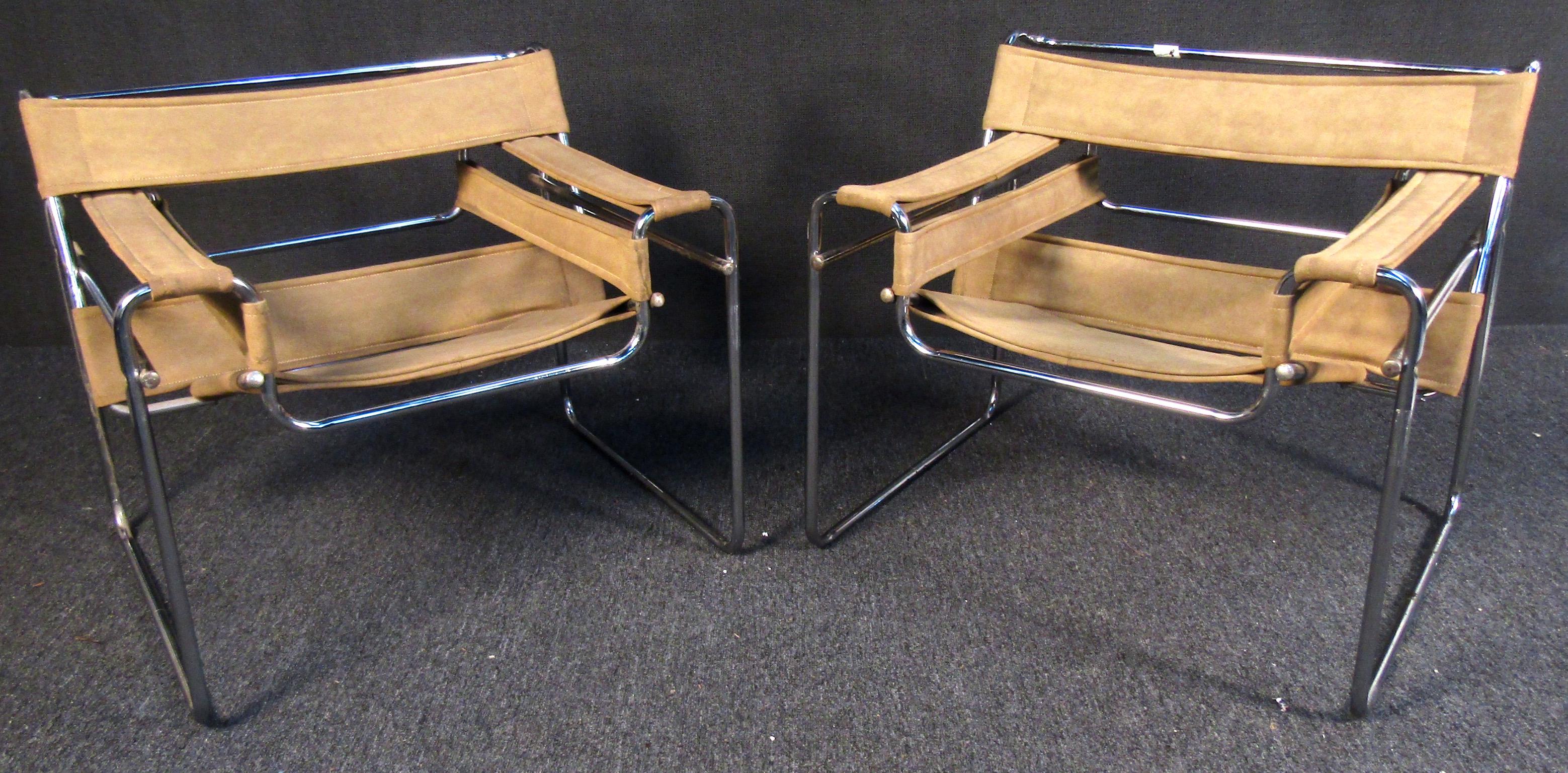Wassily style chrome frame armchairs with iconic tan straps for the seats, backs and arms. 

(Please confirm item location - NY or NJ - with dealer).