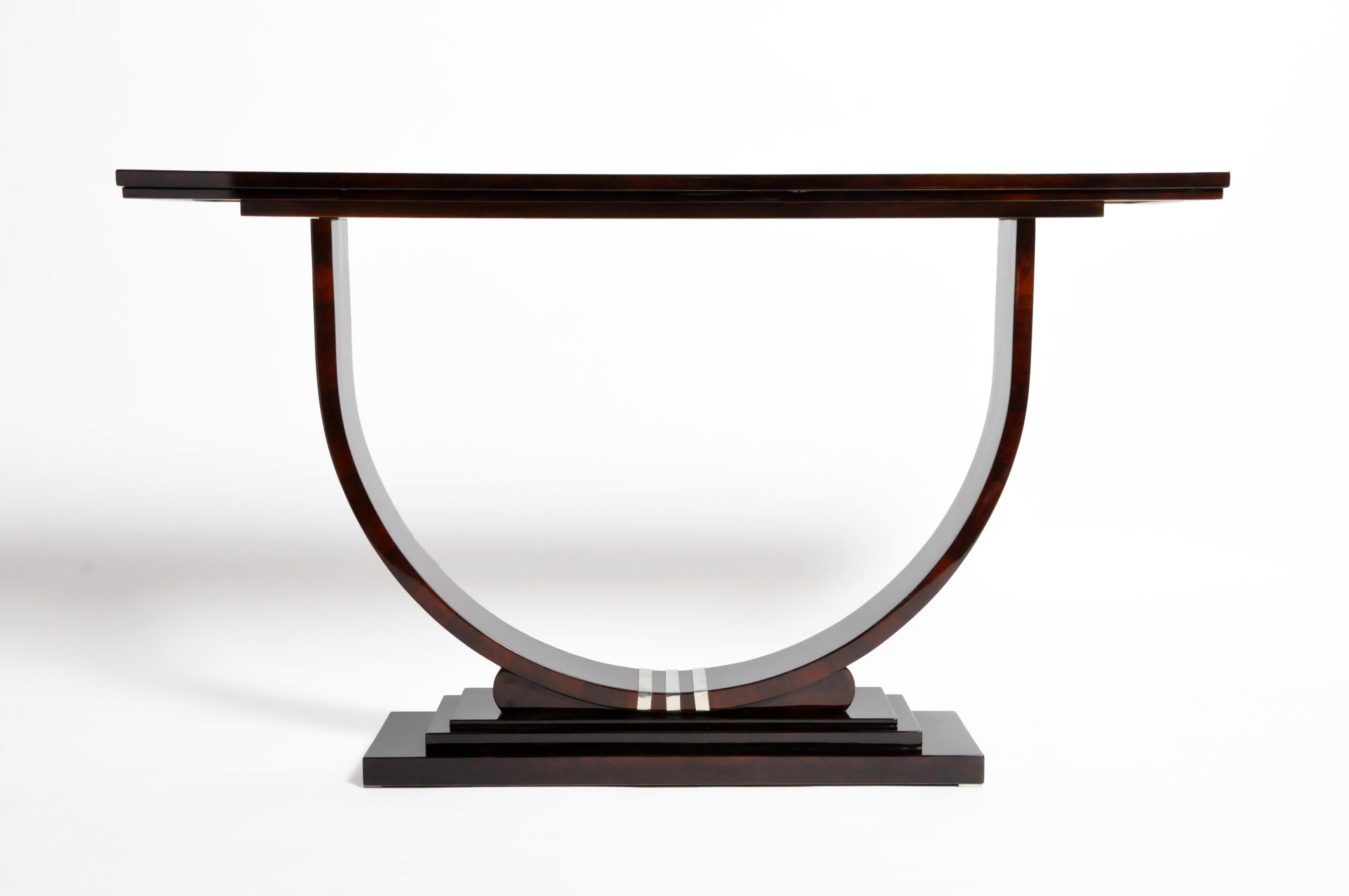 Stunning midcentury style console with dark walnut veneer and chrome accents. This piece imparts a chic, architectural elegance with its fine lines and U-shaped base.