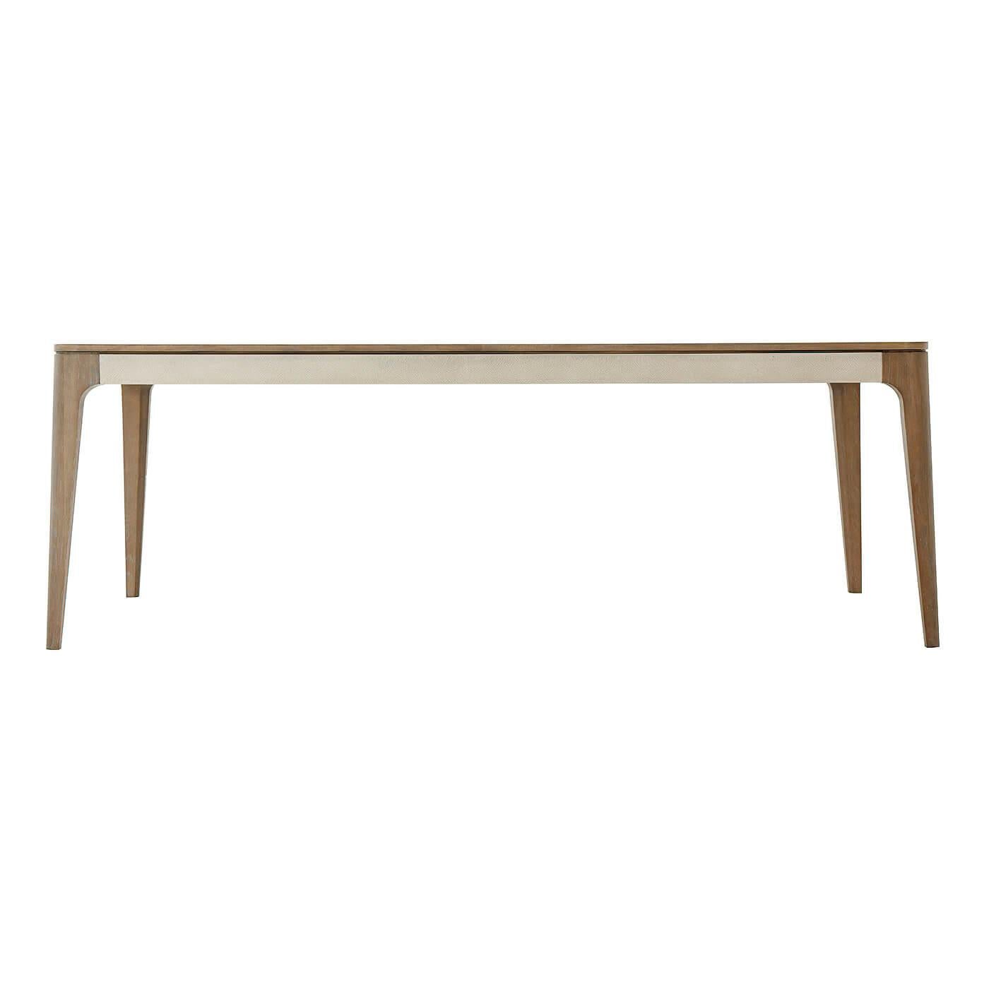 Mid-Century Modern style dining table with Mangrove Primavera veneer and Komodo embossed leather frieze with tapering beech legs and rounded exterior edges.

Dimensions: 86