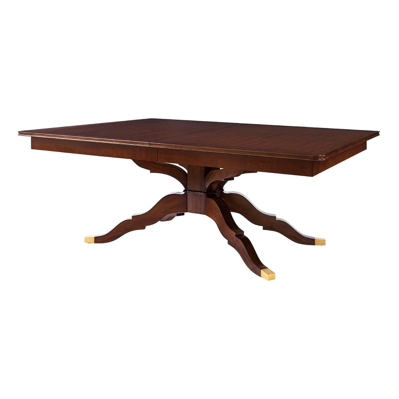 Midcentury style extension dining table with a line inlaid crossbanding and raised on an unusual four splay pedestal form base with brass sabots. Can seat up to 12 people.

Dimensions:
Open - 136