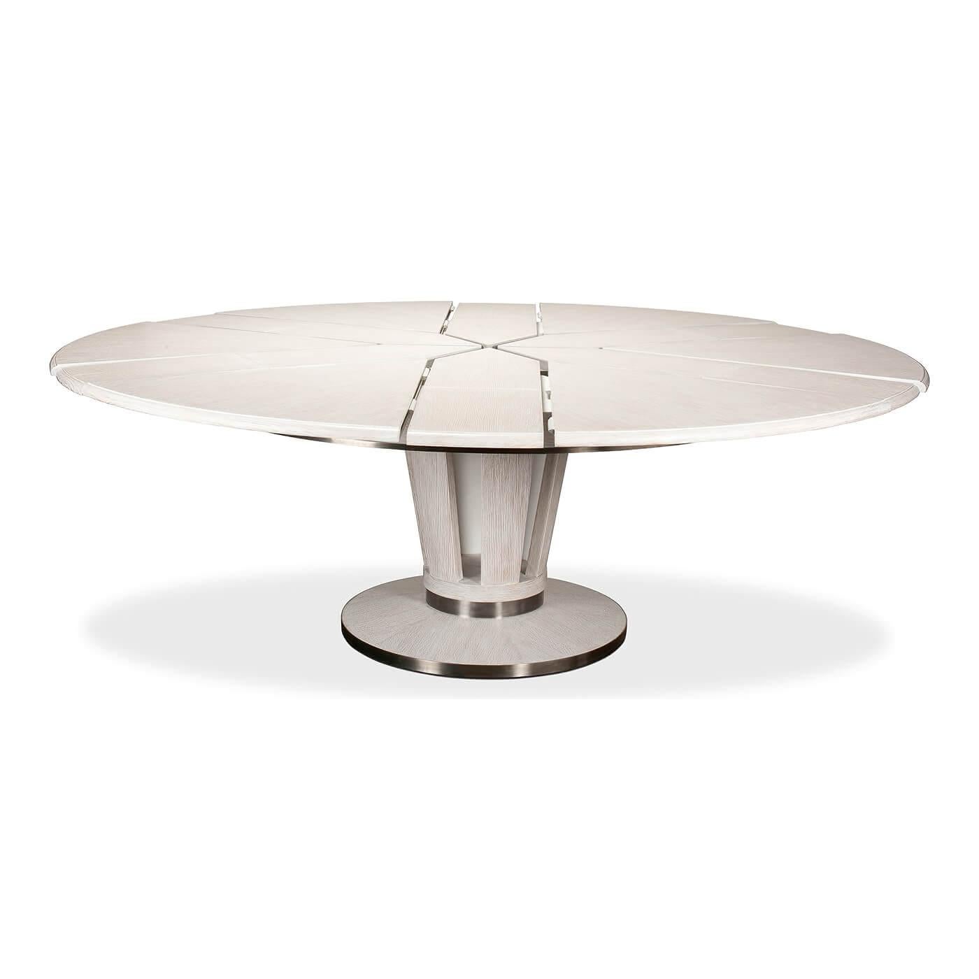 Mid-Century Modern style round extension dining table. The self-storing extension table with a dark oak stained polished top, with antique stainless steel bands to the apron and the openwork circular pedestal base.

Open dimensions: 84