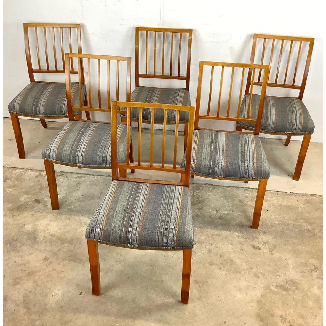 This matching set of six midcentury style dining chairs feature striking natural wood frames with sculpted seat backs and comfortable multi-color upholstered seats. The perfect set of six for dining room service or occasional kitchen seating, this