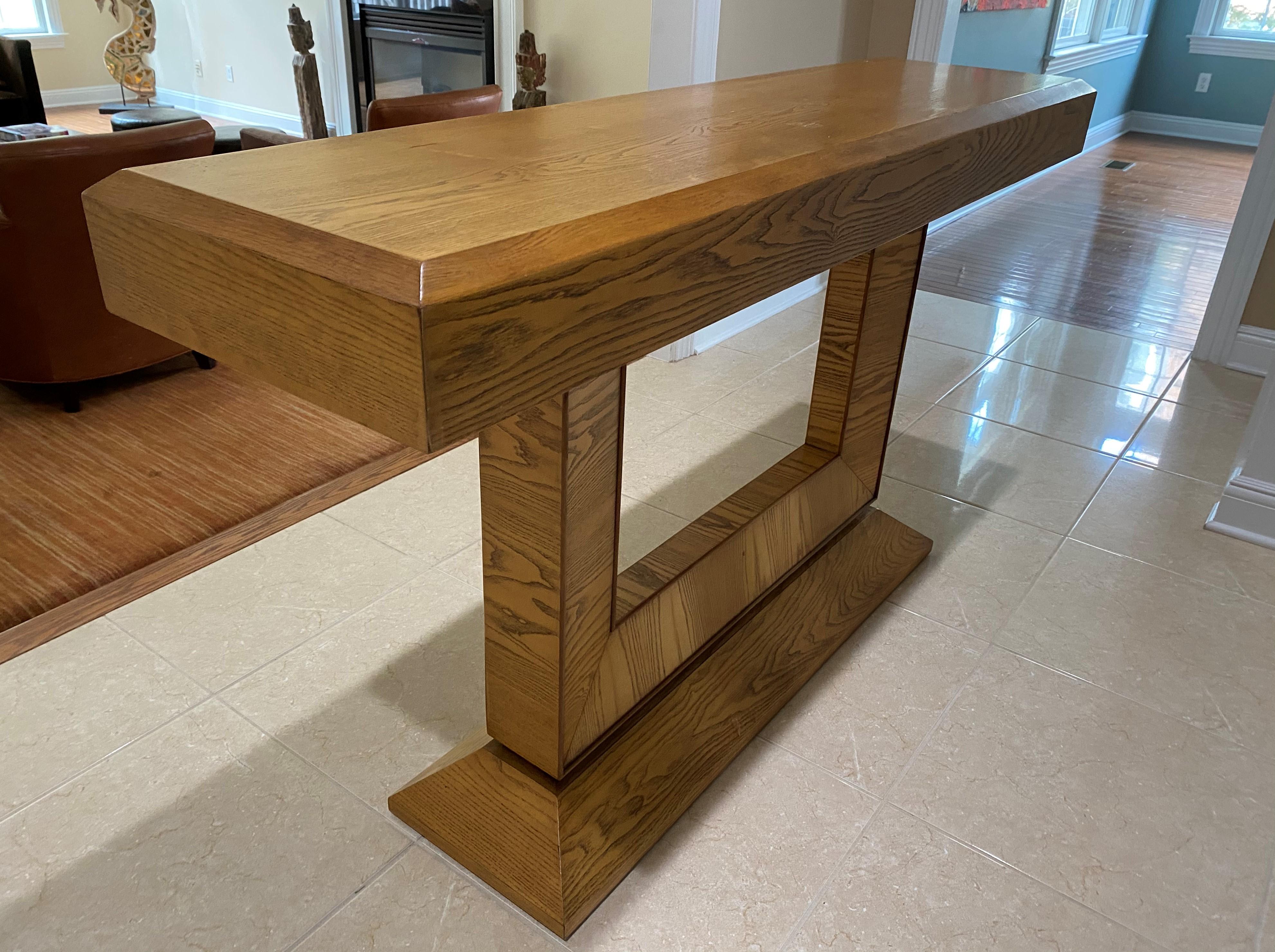 Midcentury style solid wood with a beautiful oak veneer console table with a drawer. See inside of drawer picture for the maker's mark. Clean lines with a timeless style. Interesting base.