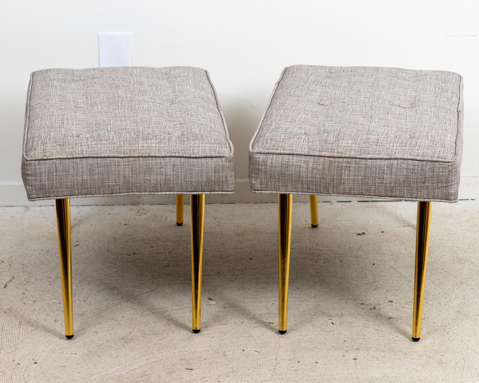 circa 21st century Mid-Century Modern style pair of benches, newly upholstered with tufted seats. The piece measures 30.00 Inches by 18.00 Inches by 18.00 Inches.