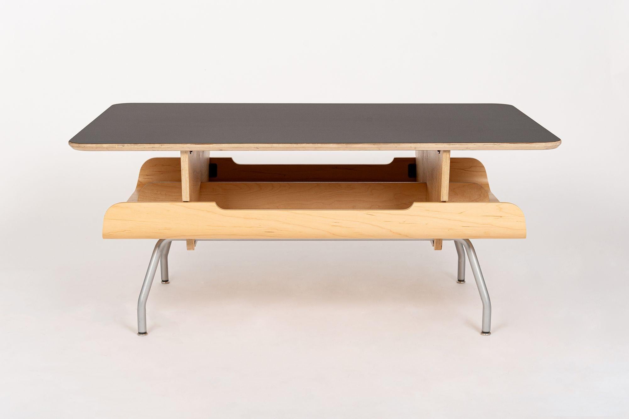 This contemporary mid century modern inspired Kotatsu coffee table was designed by Ayako Takase and Cutter Hutton in the 1990s and produced by Herman Miller in 2008. This rectangular coffee table made from maple plywood and maple bentwood veneer