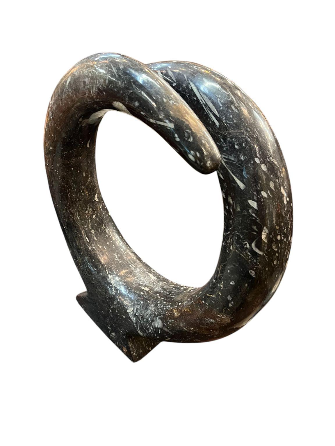Mid Century style polished Orthoceras fossil sculpture. A beautiful circular design that would be the focal point of any room. Dimensions 19 inches high by 18 inches wide and 6 inches deep.