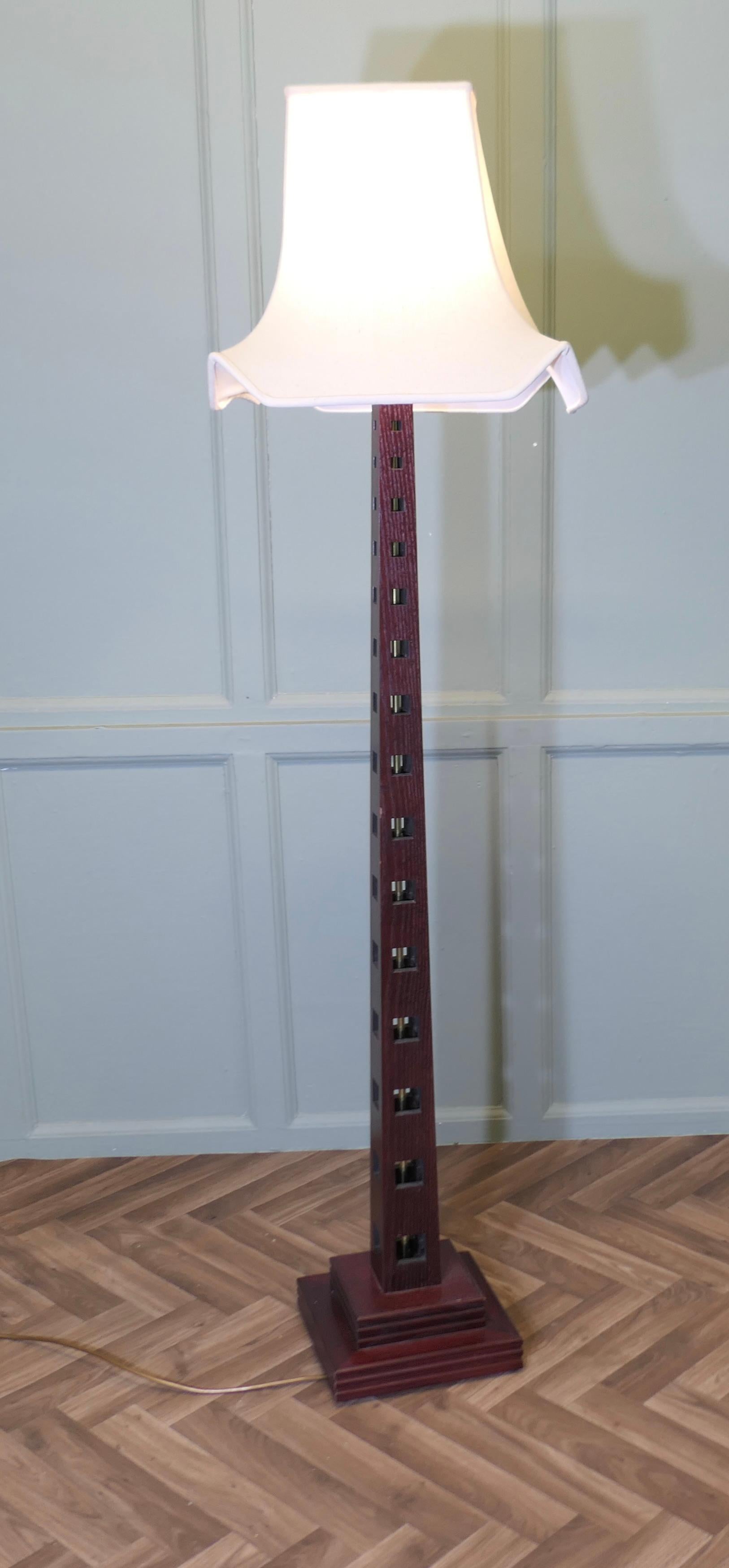 Mid Century Style Teak Standard or Floor Lamp 
This is a very stylish piece, it has a tall pierced tapering column in teak, in side this it has a brass support on a stepped base, the lamp comes with a square lampshade, it is in good working