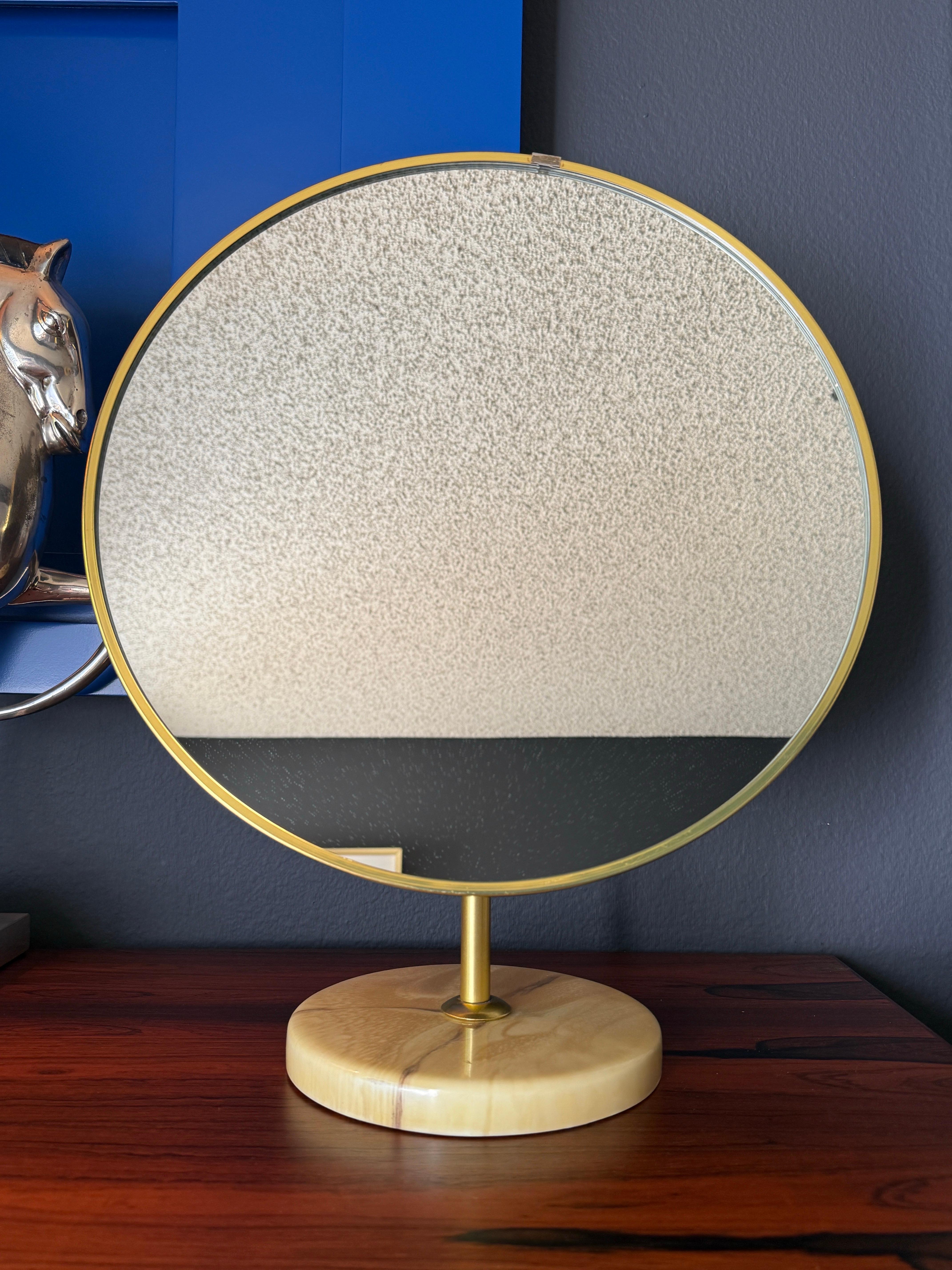 Mid century modern style round vanity mirror on a faux marble base by Schreiber