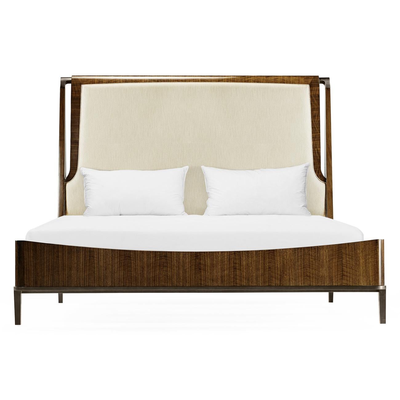 A midcentury style quartered walnut king size bed with an upholstered headboard and antique brass hardware and feet.

Dimensions: 82 1/4
