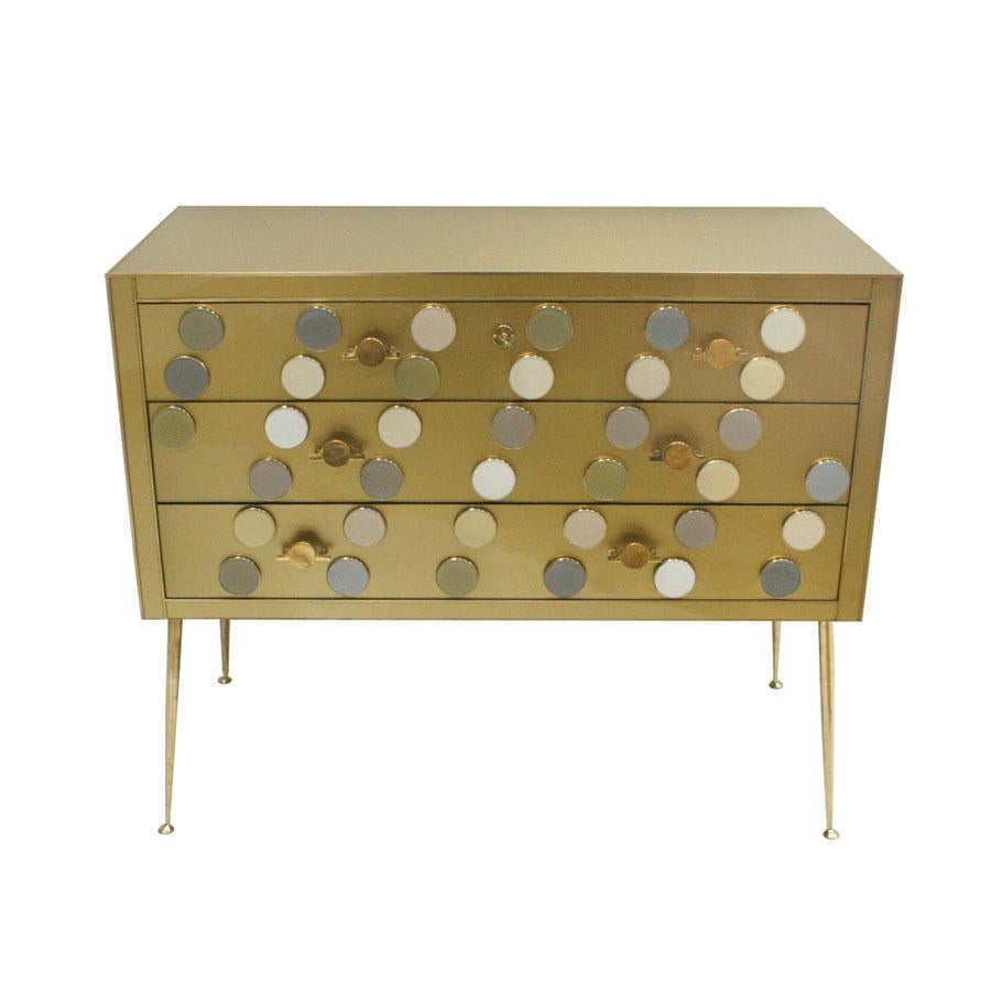 Contemporary commode designed by L.A. Studio and manufactured in Italy. Composed of three drawers decorated with Murano glass pieces. Original structure from 1950s covered with colored glass. Legs handles and details are made of brass.

Our main