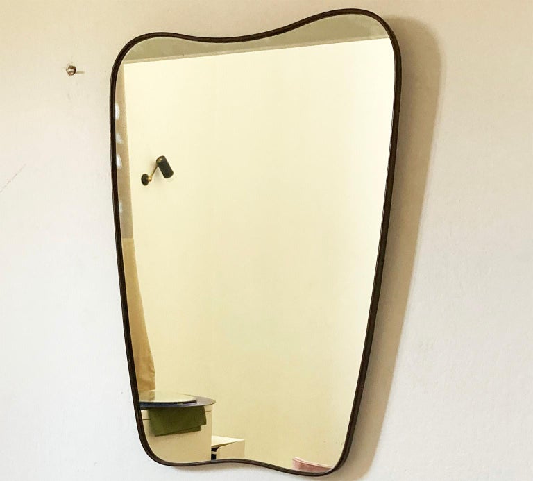 Fine wall mirror Fontana Arte MIlano  manufacturer,
 with original brass  beautiful patina.
The sweet shape and well proportioned give to this mirror an elegant touch feminity.

