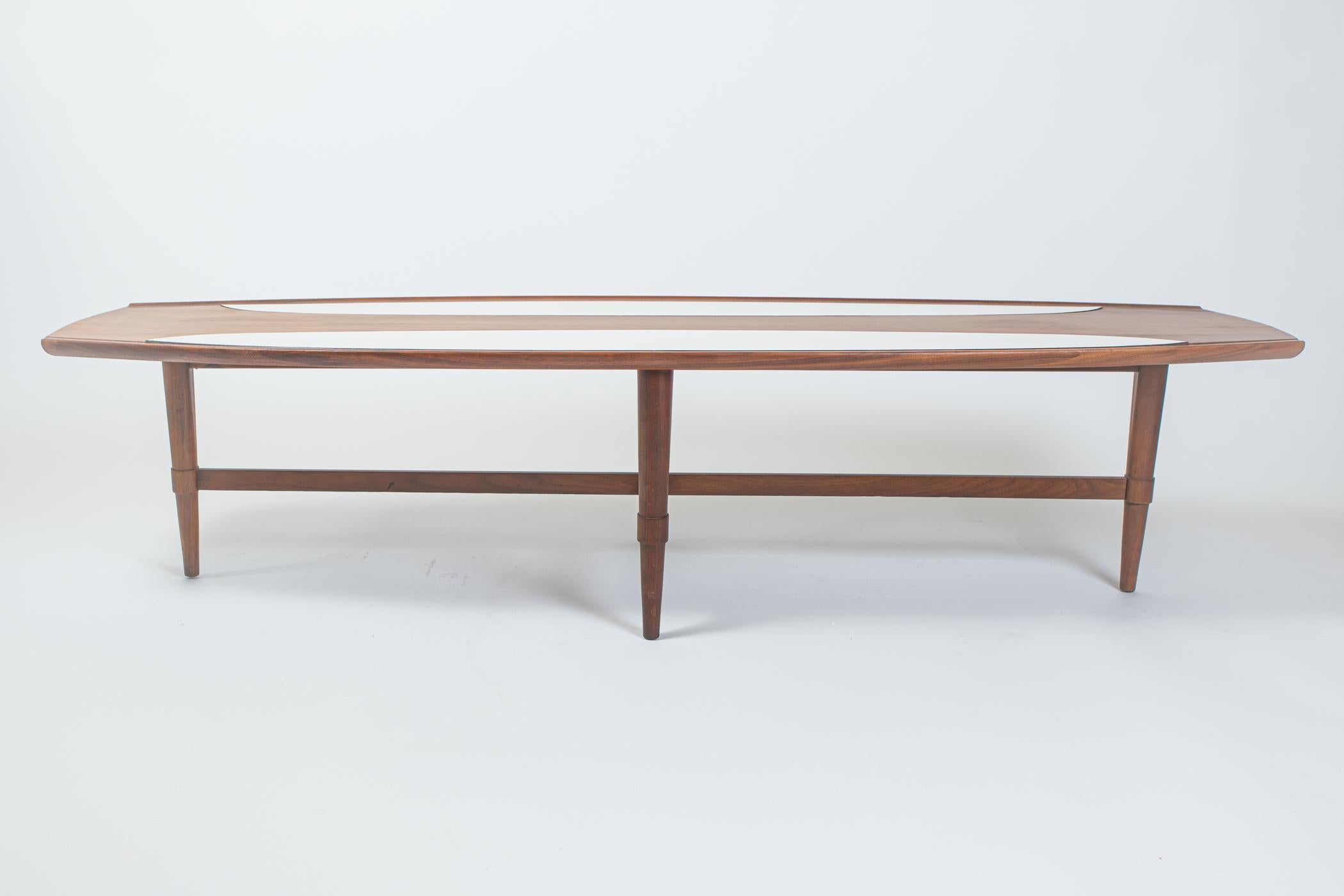 Authentic vintage walnut surfboard coffee table with white laminate accents. This piece takes its inspiration on the Classic design on surfboards. The Classic surfboard shape receives a modernist touch with the contrasting white laminate panels.